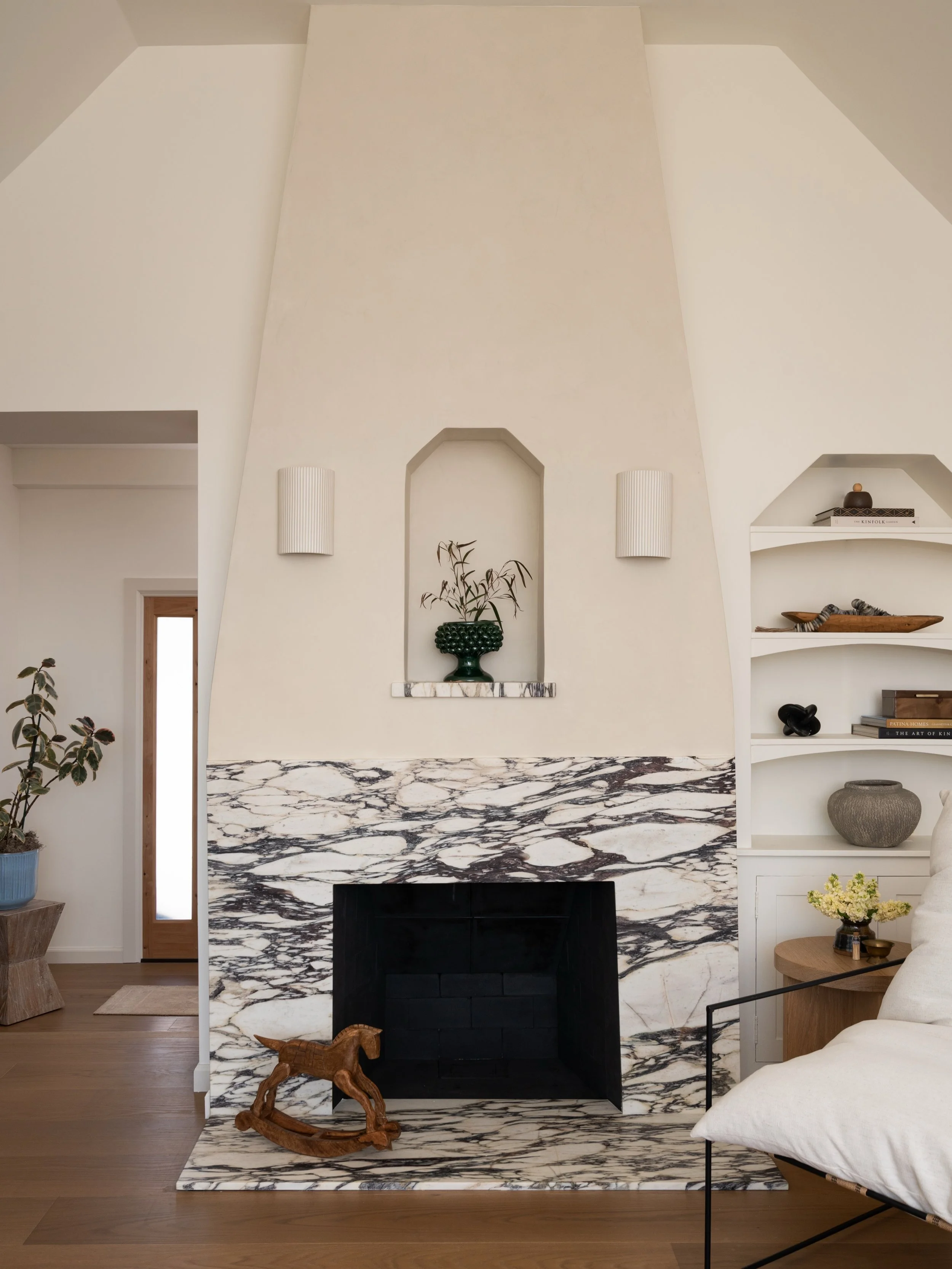 The fireplace at Project #StayInRoundTop had great bones - the shape, the height, and the sweetest niche that echoes the angles of the ceiling and original built-ins. It just needed the right materials to truly become the focal point of the room. 

W