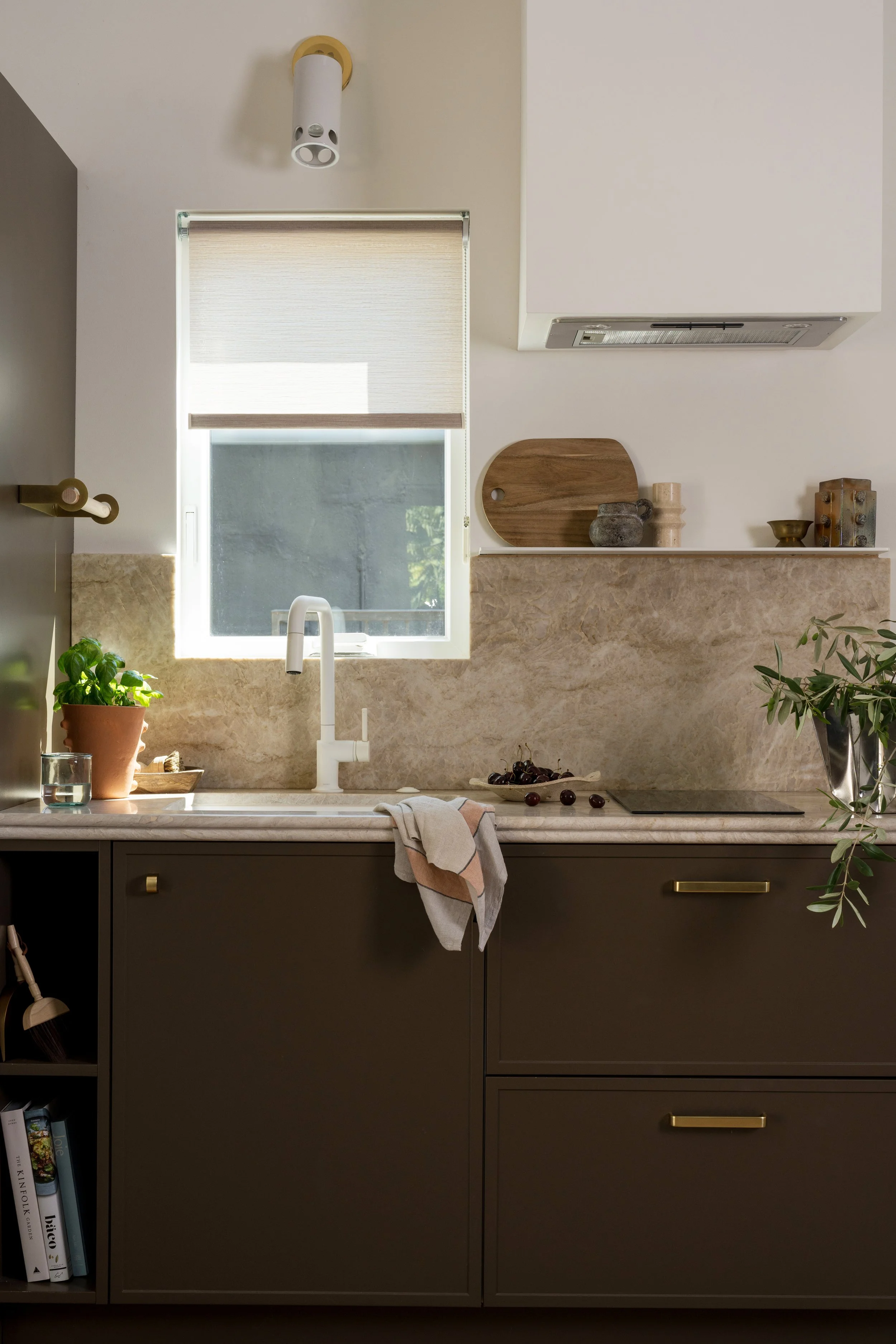 kitchen cabinetry with a light stone counter and backsplash creating a clean, modern look.