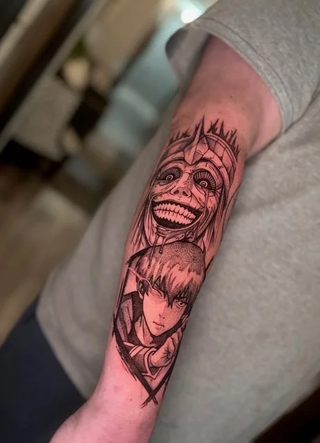 Tattoo of a sinister smiling skull above a serious anime-style character on person's arm.