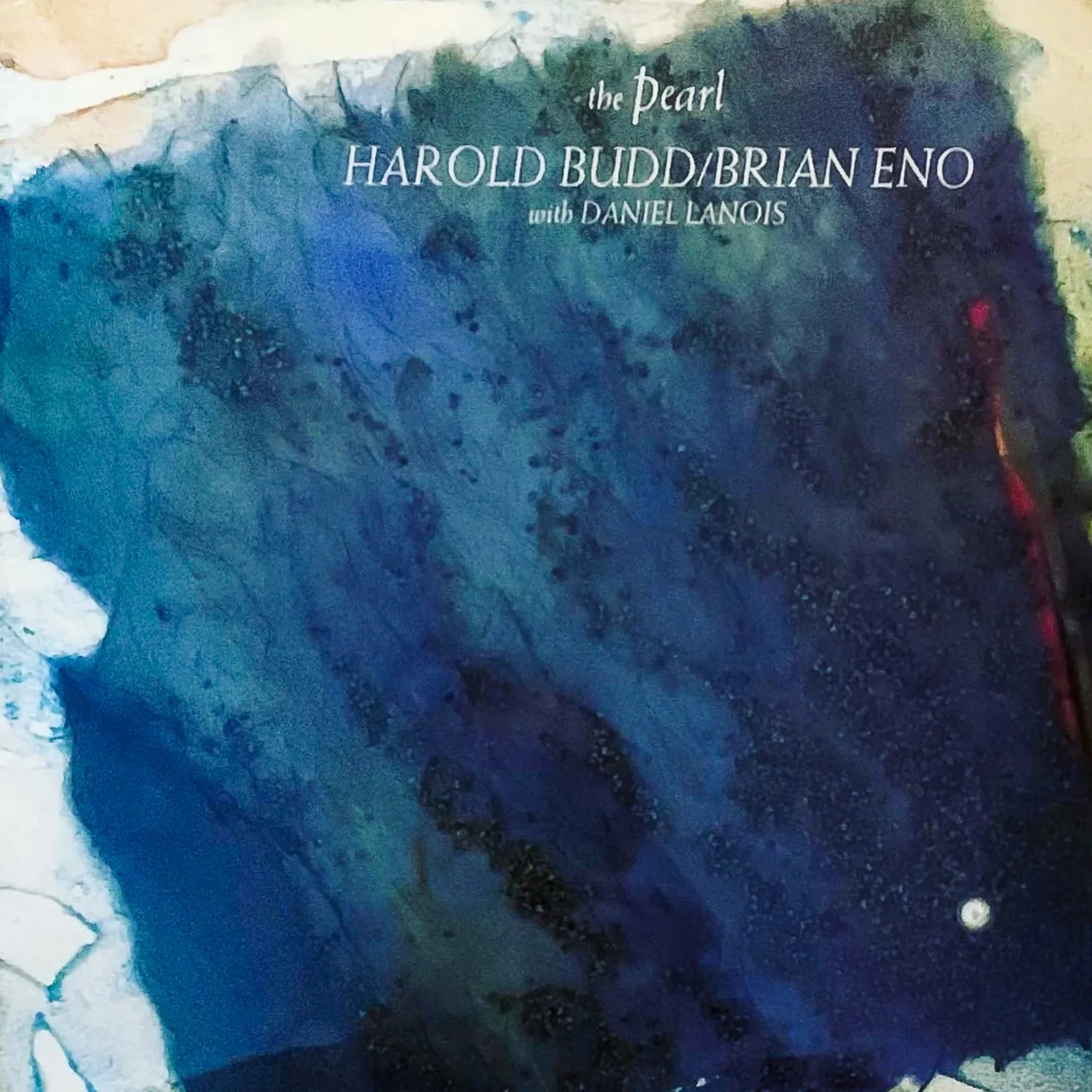 Cover of a booklet or CD titled 'the Pearl' by Harold Budd/Brian Eno with Daniel Lanois, featuring a blue abstract painting or photograph of an ocean or water scene.