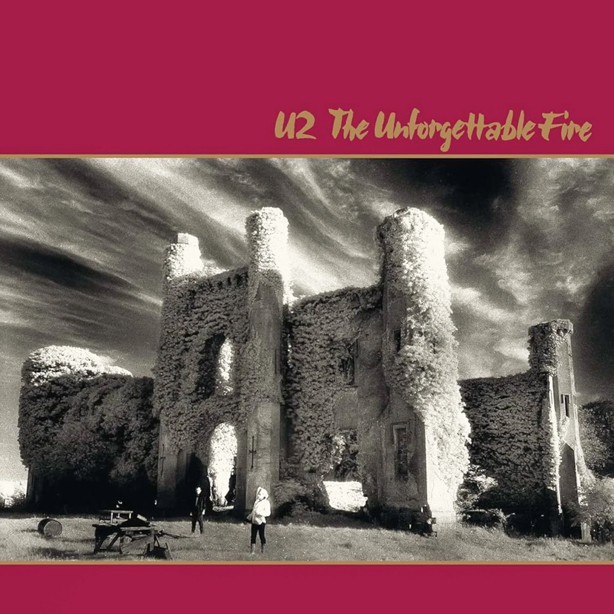 Album cover for U2's The Unforgettable Fire featuring a black and white photograph of a castle with overgrown foliage and a dramatic cloudy sky.