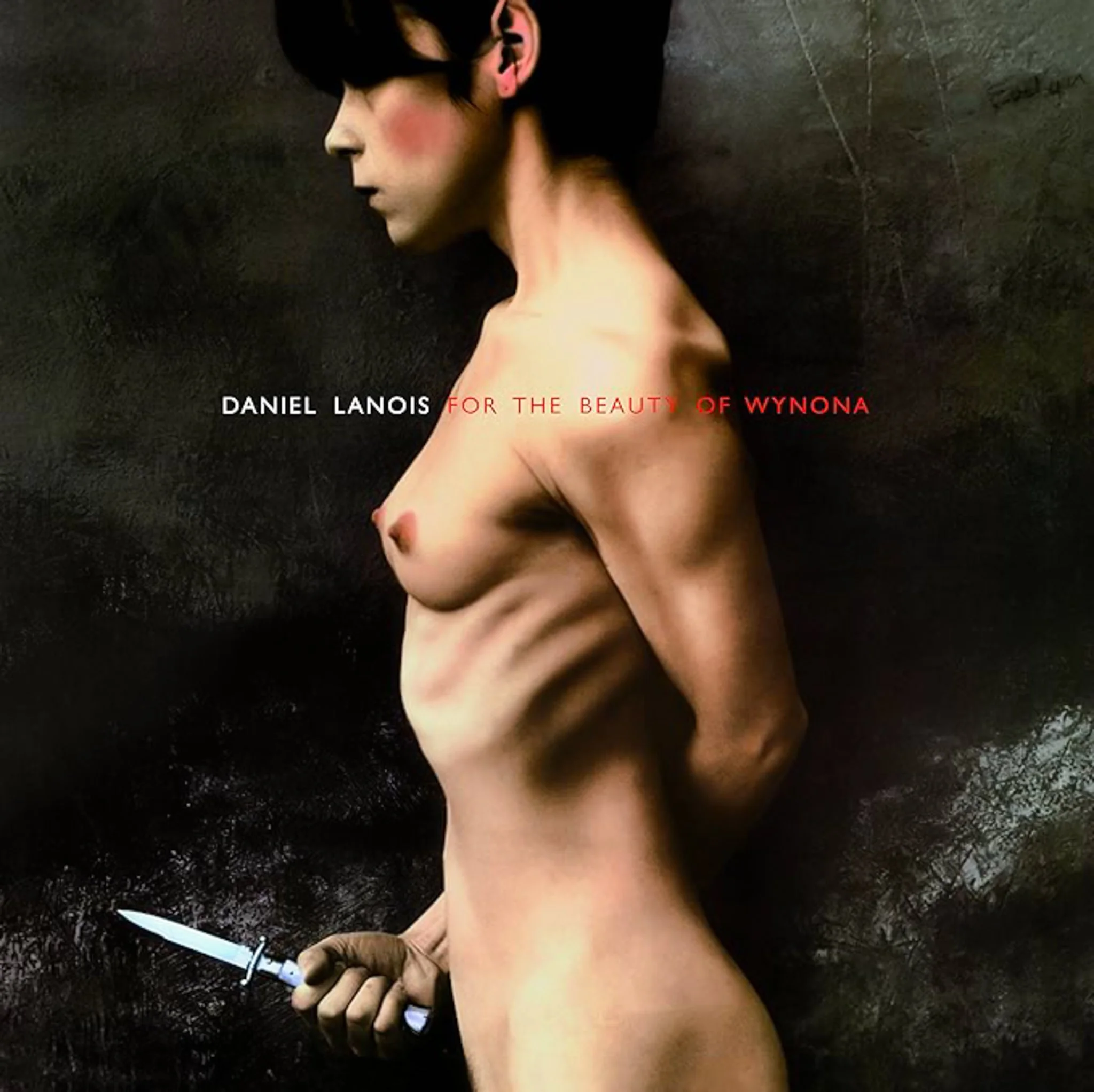Cover art featuring a partially nude woman with short hair, holding a dagger in her right hand, against a dark, textured background. The text reads: 'Daniel Lanois for the beauty of Wynona'.