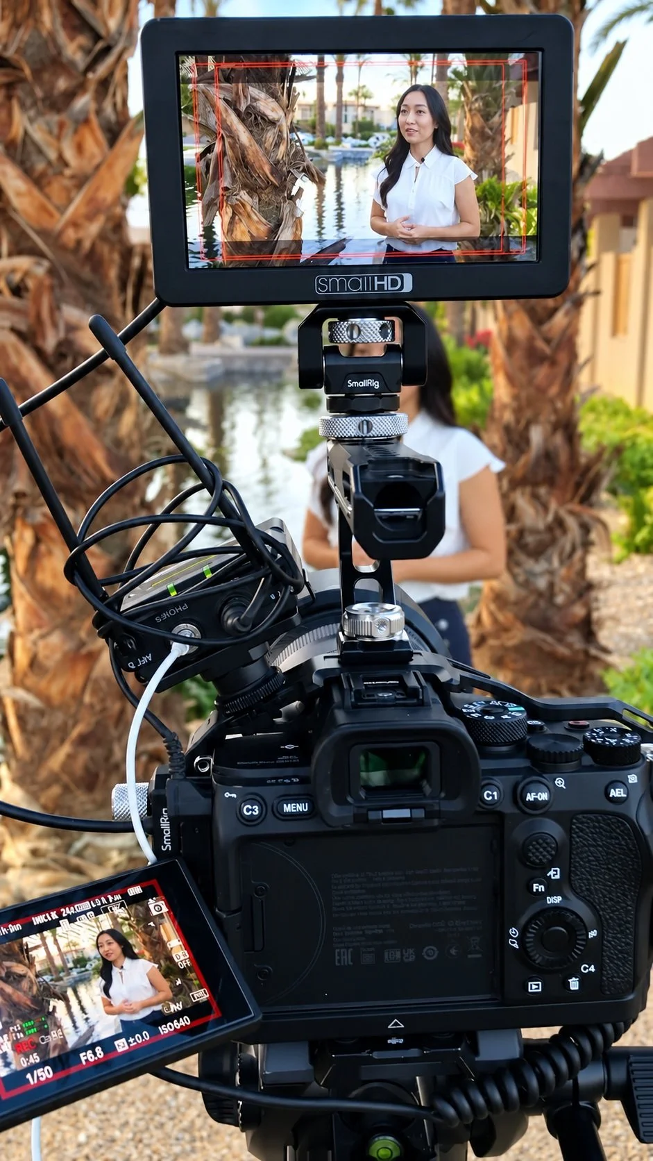 A Poema Media camera recording a client outdoors, with the client visible on the field monitor.