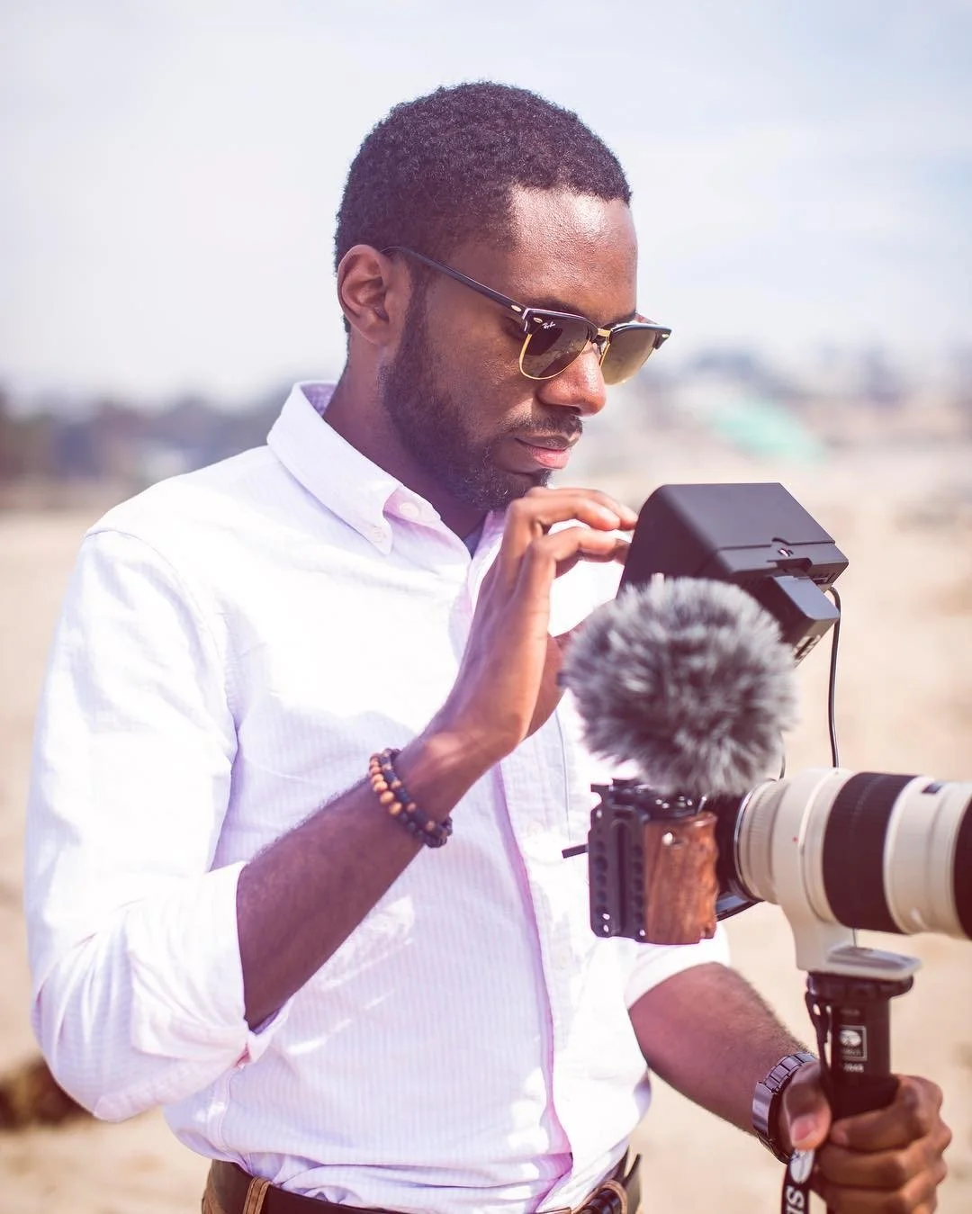 Shane from Poema Media adjusting a camera on location.