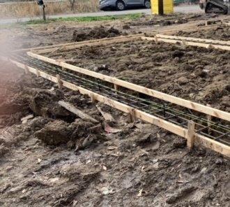 Construction area with wooden forms and metal rebar for a concrete foundation