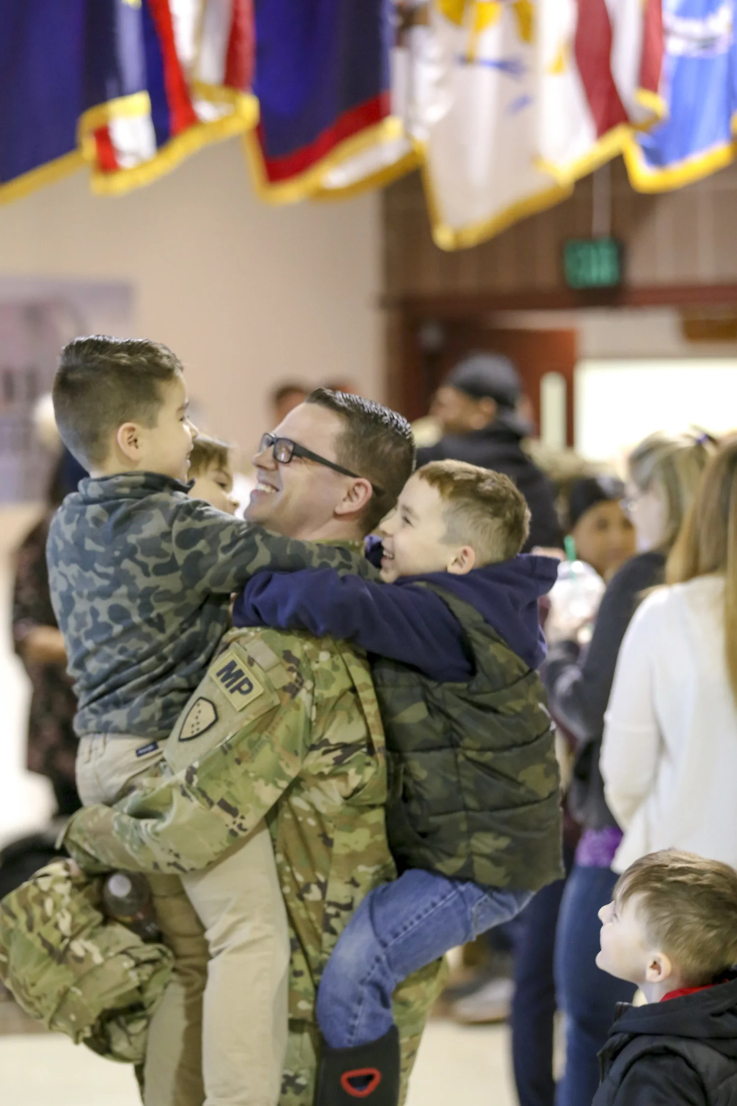 Service member hugging his children