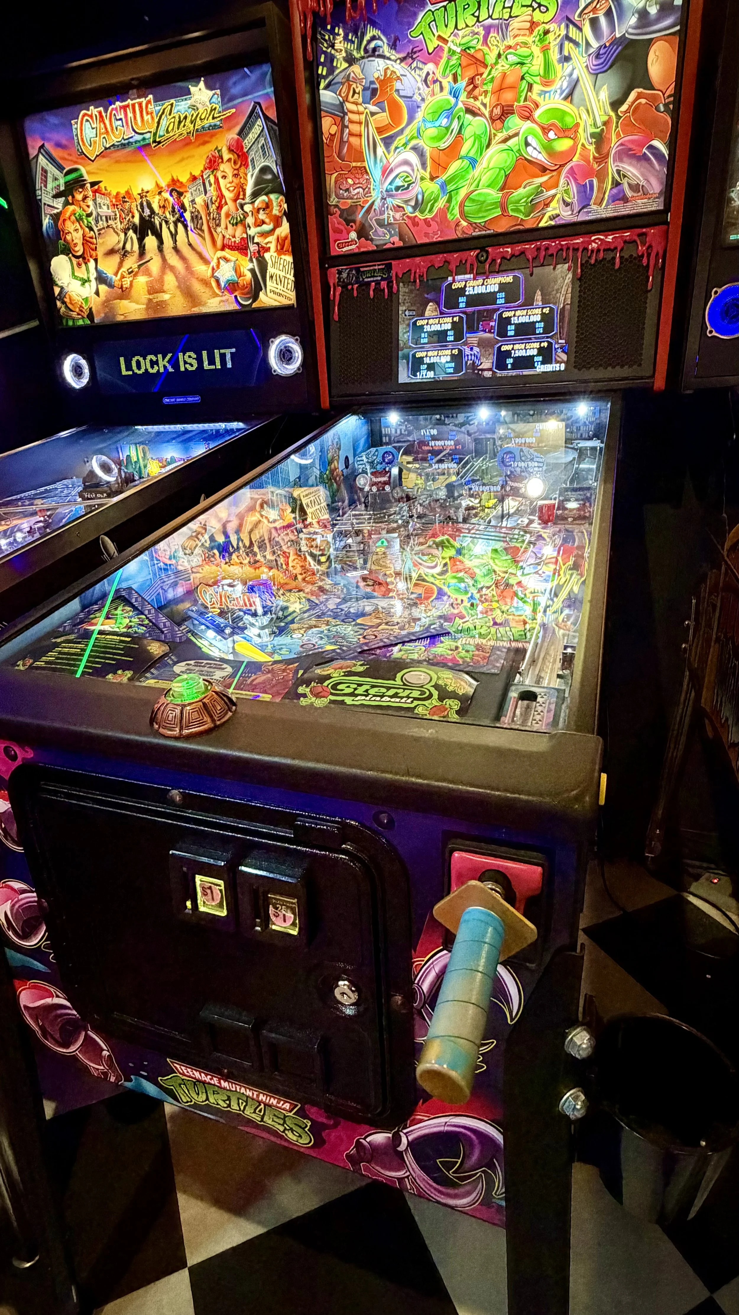 A Teenage Mutant Ninja Turtles pinball machine in an arcade setting.
