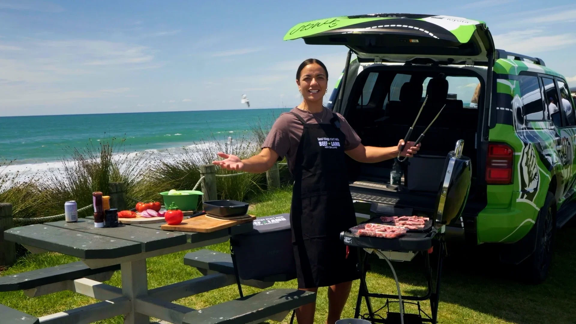 Stacey cooking lamb chops beachside with her lamb cruiser.