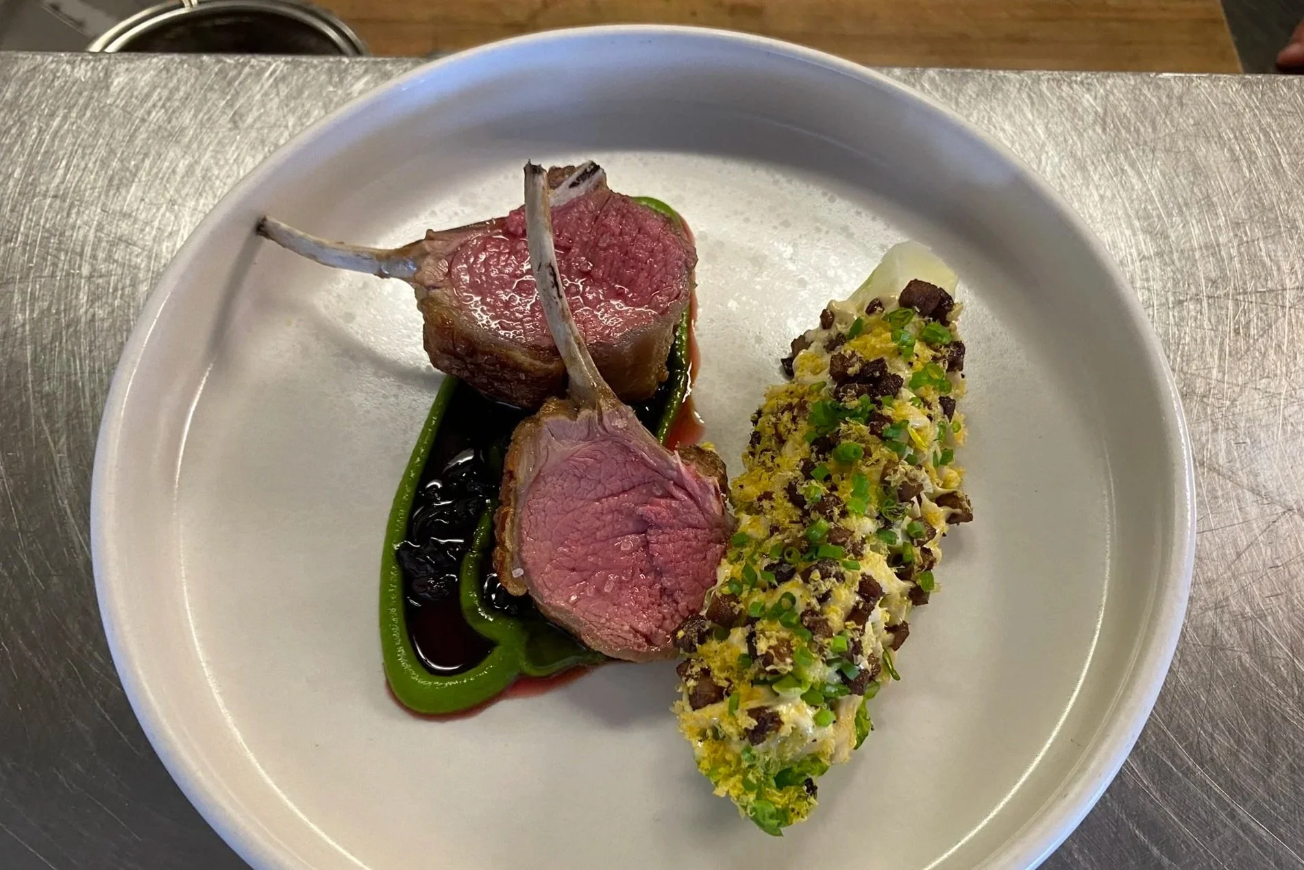 New Zealand lamb rack with Caesar salad and black olive by Ambassador Chef James Bratton