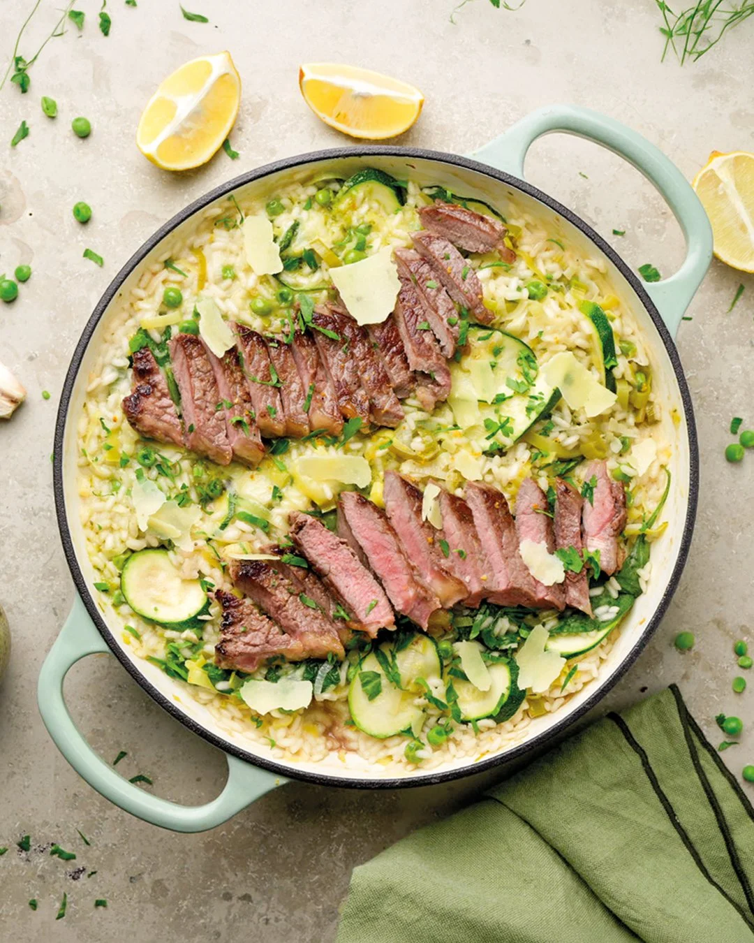 Sliced steak on a green risotto with courgette and parmesan