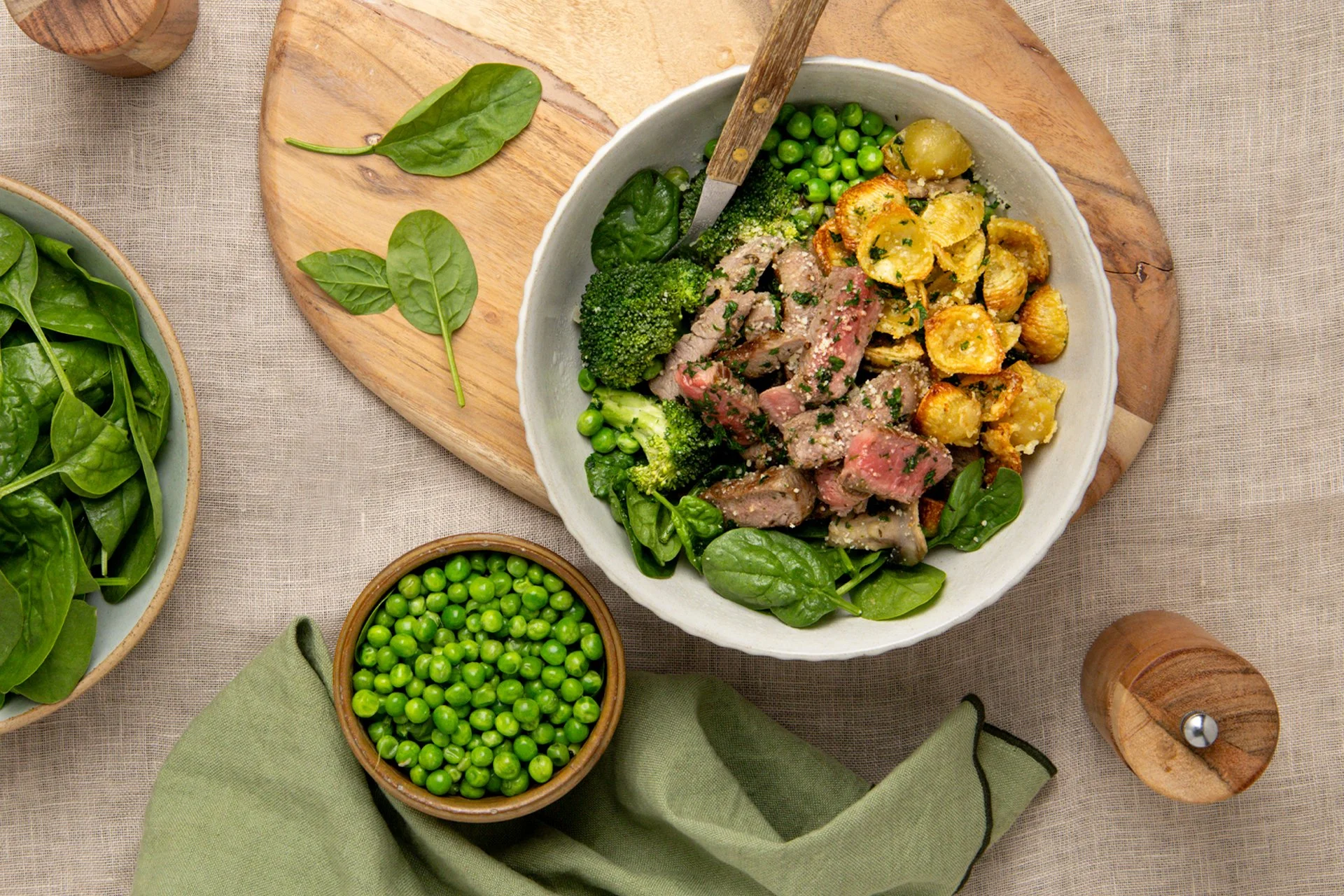 Steak Alfredo with pasta chips, peas and spinach