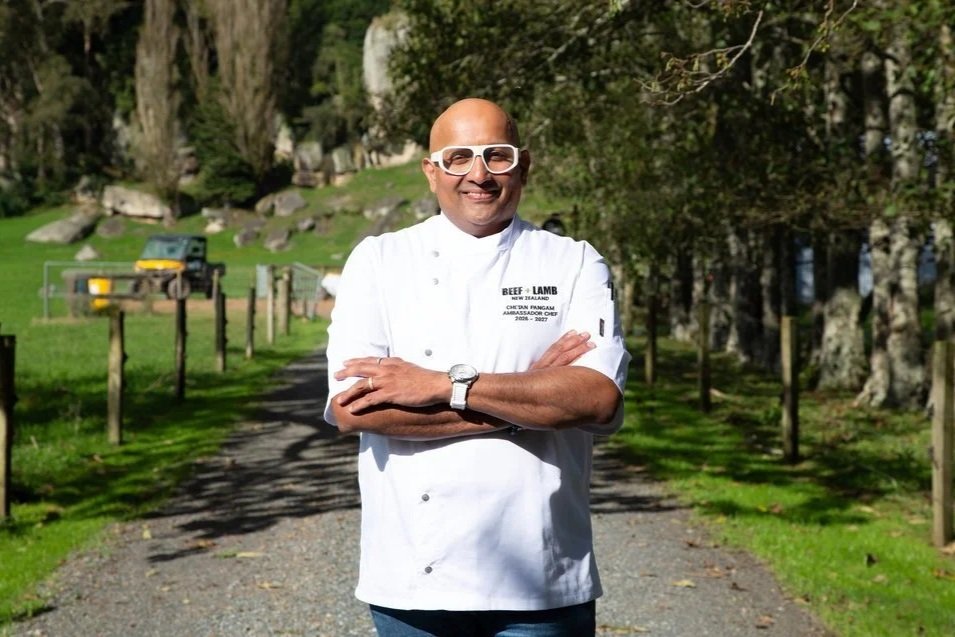 Chef in chef jacket standing outside in a rural lane