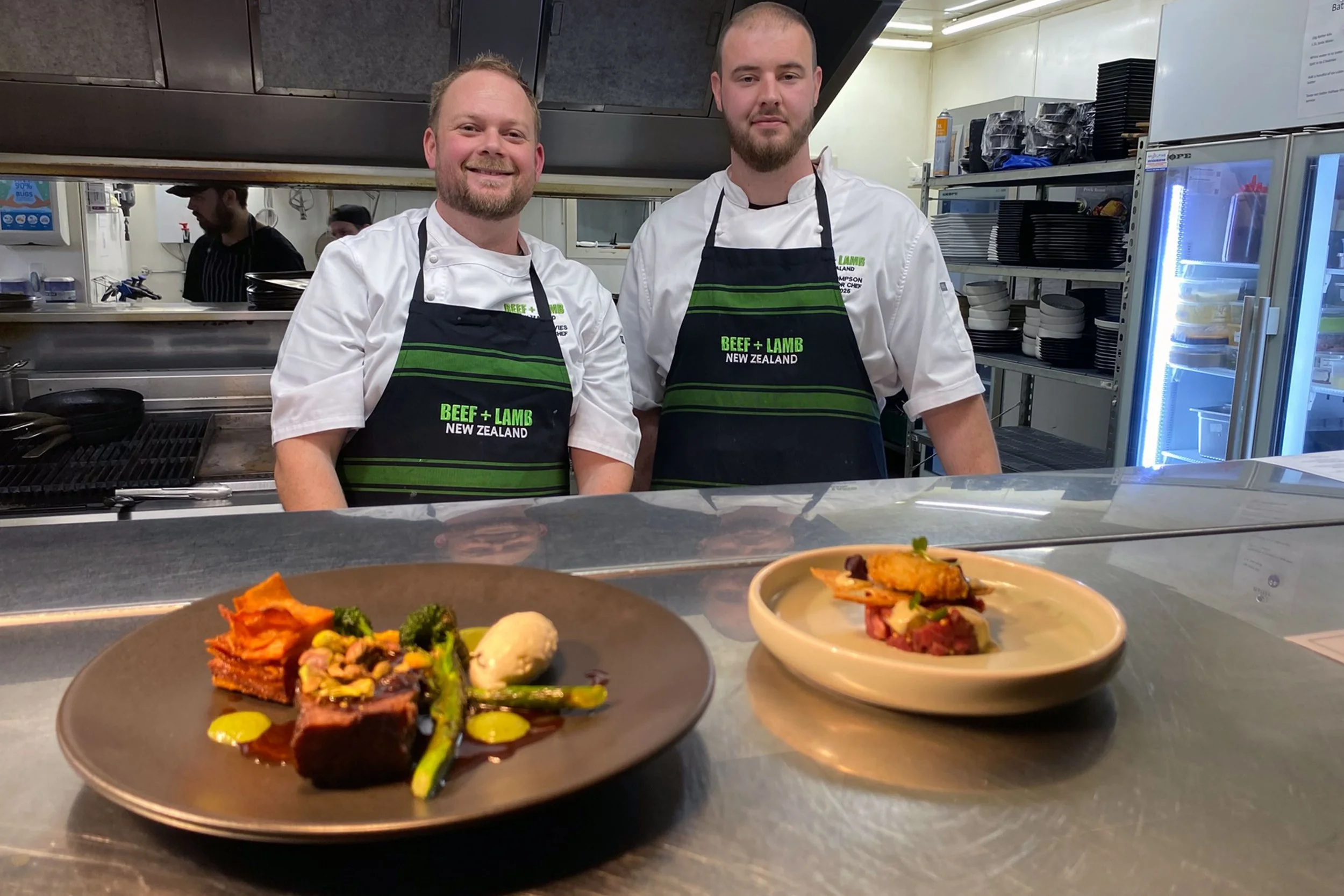 Chefs Cam Davies and Dean Thompson standing together in The Fat Duck kitchen in Te Anau with their finished dishes