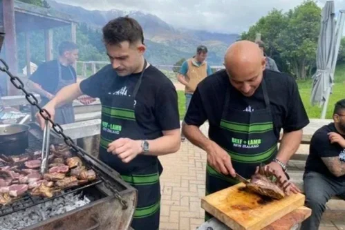 Chefs Nic Kearney and Chetan Pangam cooking lamb on a barbecue at Royalburn Station