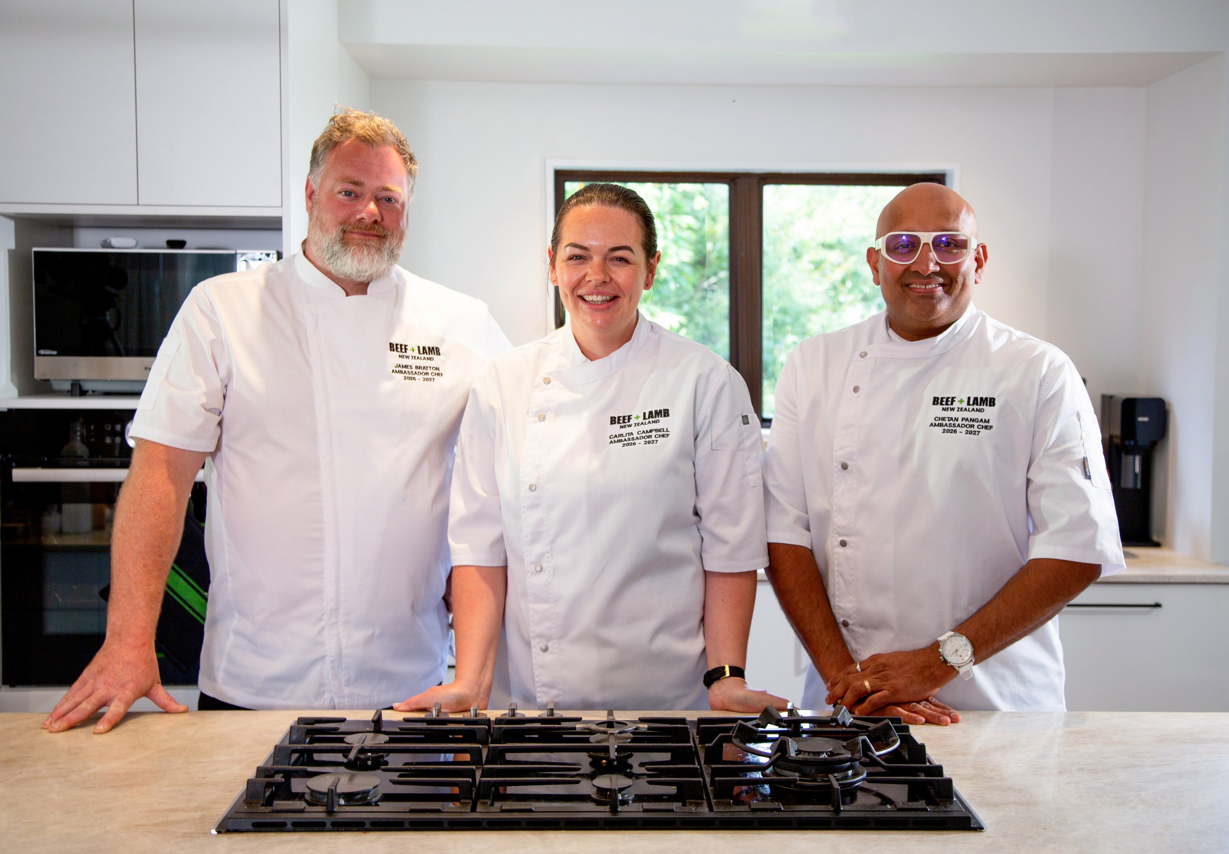 The three 2026-2027 Beef + Lamb Ambassador Chefs smiling together in a kitchen