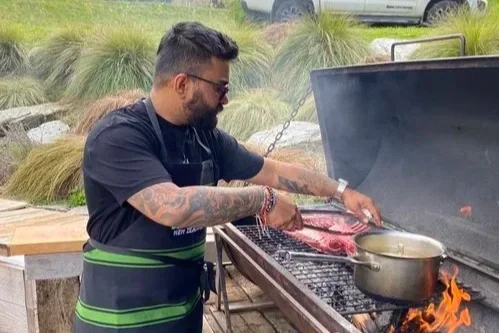 Chef Mrinal Ghosal cooking outdoors at Royalburn Station