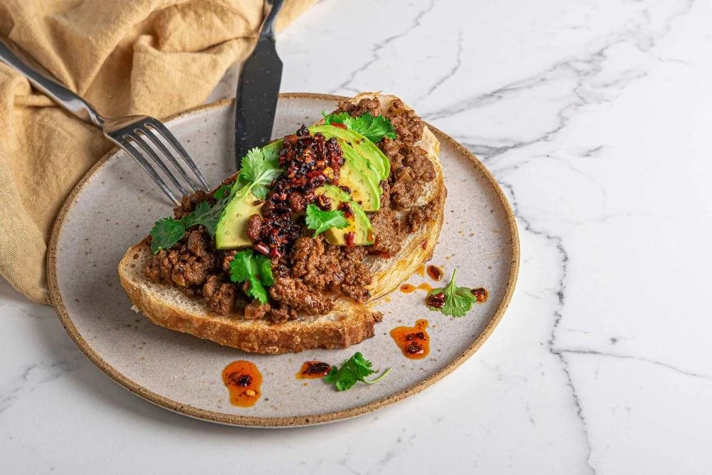 Spiced beef mince on toasted sourdough topped with sliced avocado, chilli oil and fresh coriander.