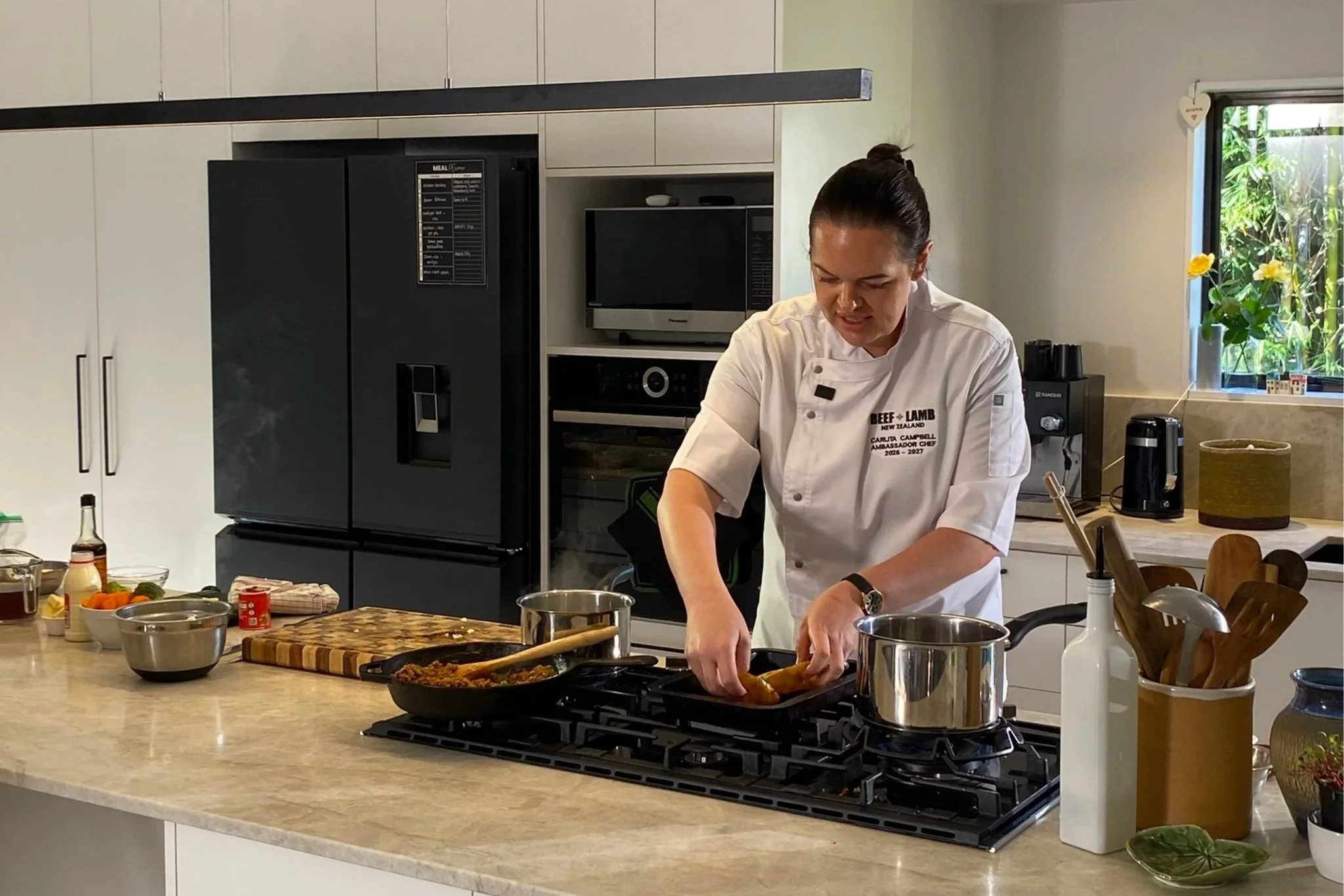 Carlita Campbell cooking her shepherds pie jacket potatoes in the kitchen