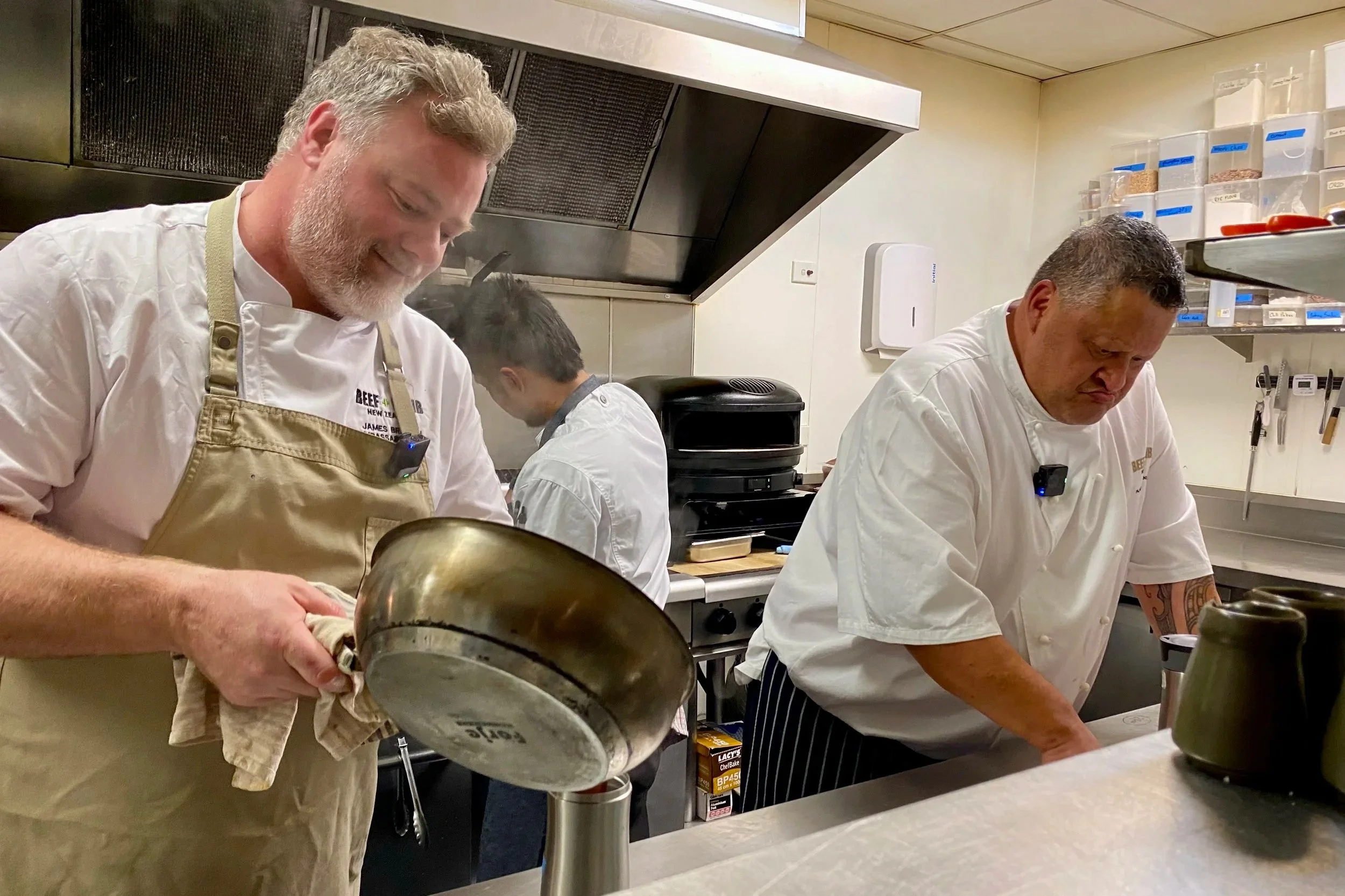 Ambassador Chefs James Bratton and Rex Morgan cooking together in the kitchen at Moxie Restaurant