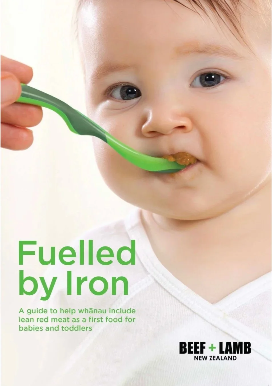 Cover of the Fuelled by Iron guide from Beef + Lamb New Zealand, showing a baby being spoon-fed