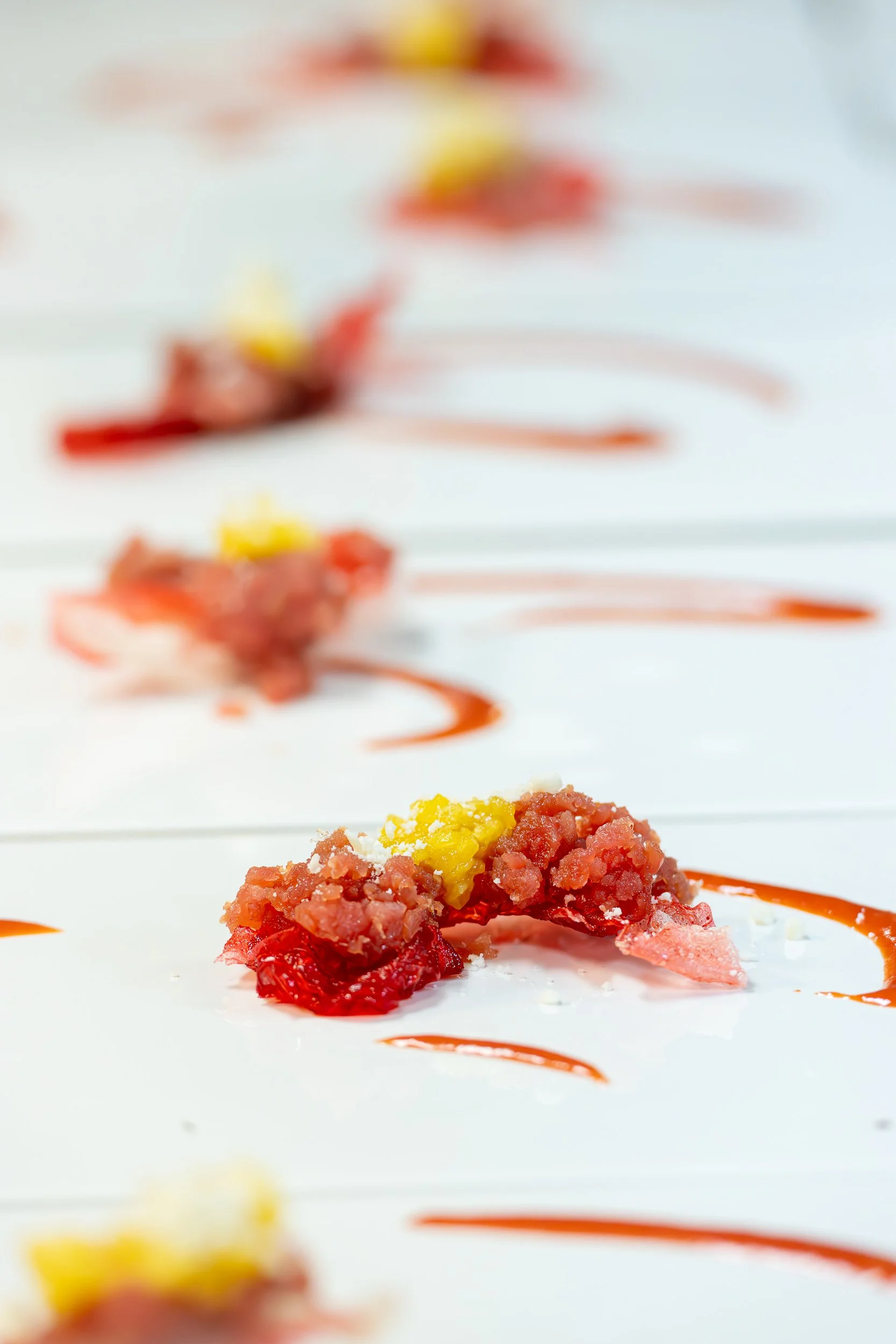 Tuna tartare with red sauce on white plate, fine dining restaurant food photography