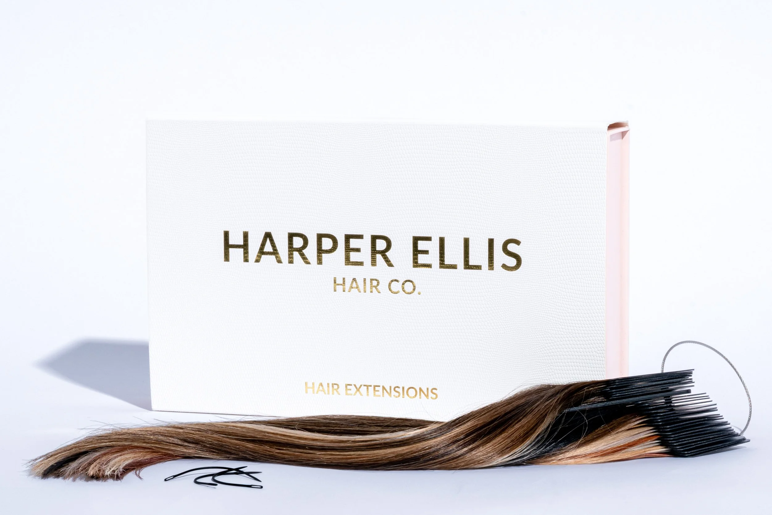 Harper Ellis Hair Co. branded box with hair extensions and styling clips on white background