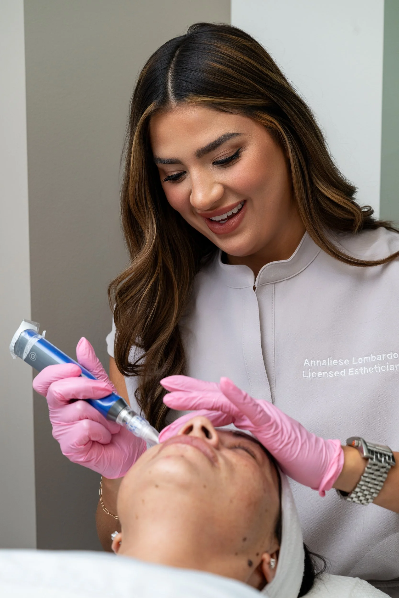 Bella Derma provider performing a facial treatment during a patient appointment.