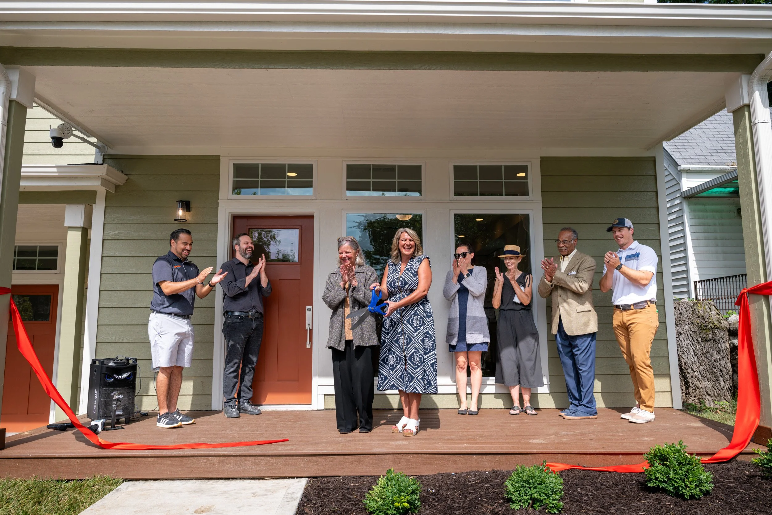 Community leaders celebrate the ribbon cutting for reStart's Family Lodge.