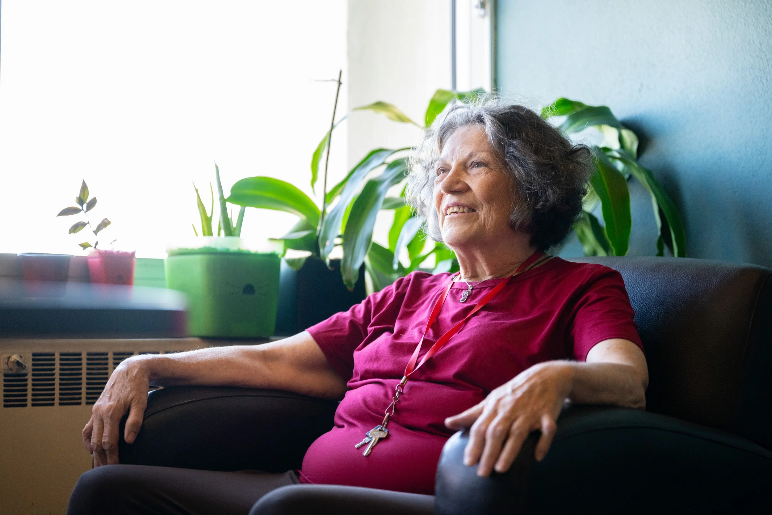 Portrait of a reStart resident seated beside a window inside the Family Lodge.