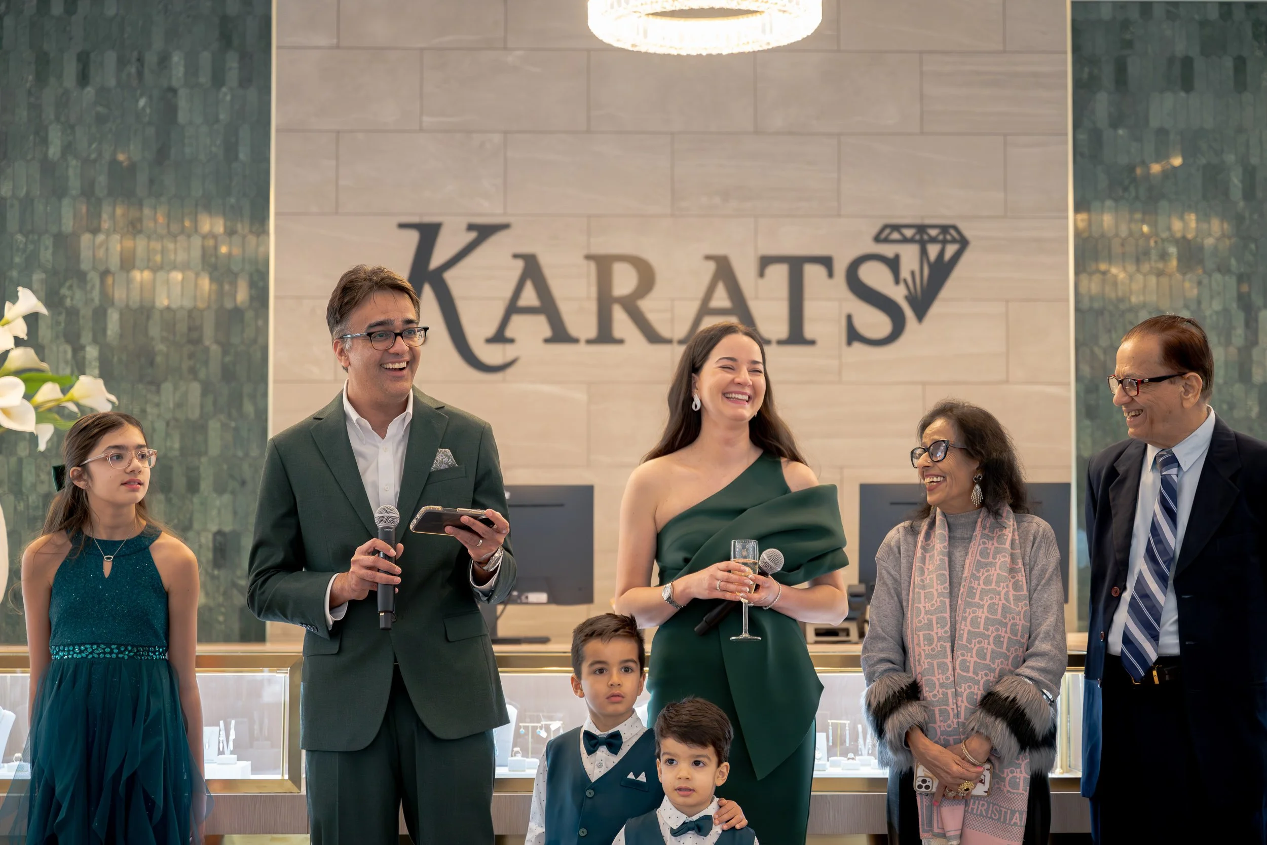Karats Jewelers owner Andy speaking with family during the flagship store opening celebration.