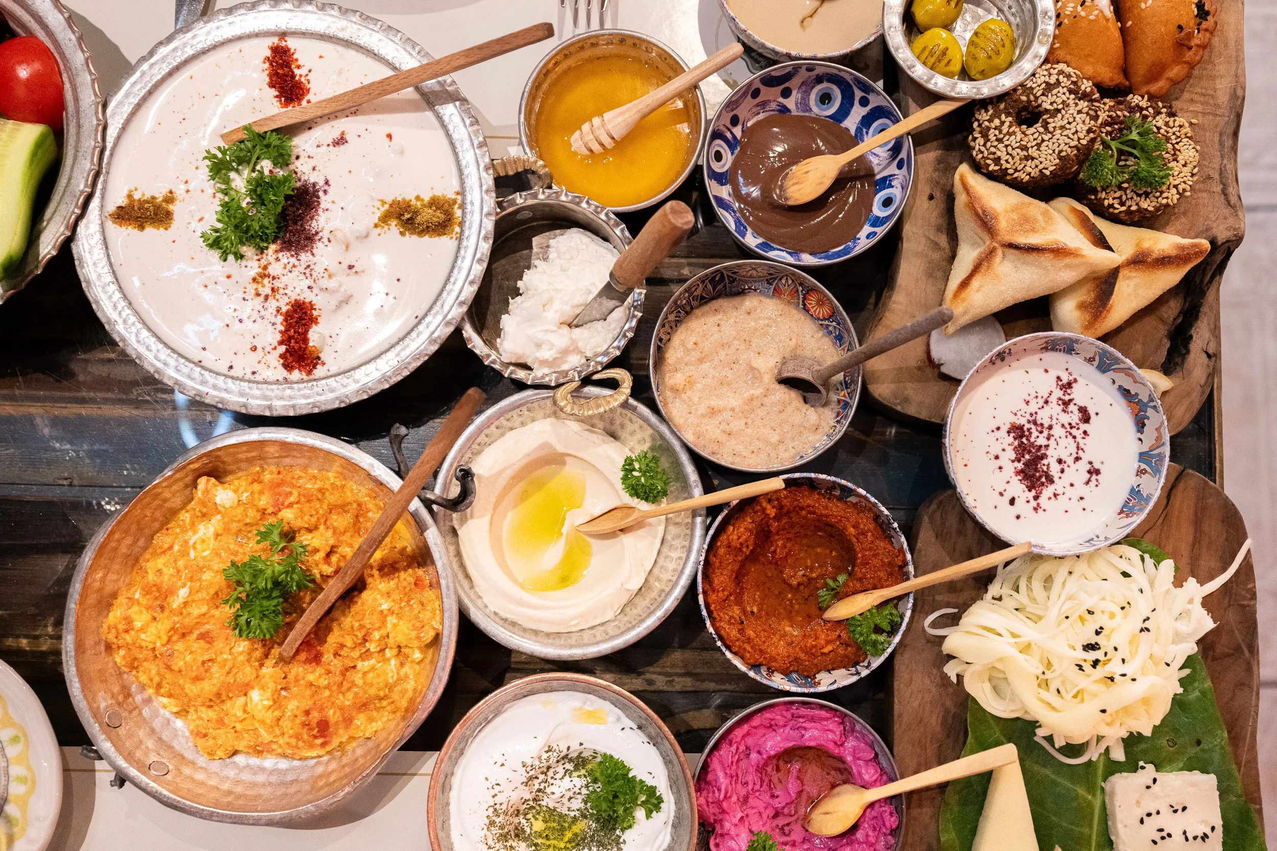 A vibrant Turkish breakfast spread celebrates abundance through shared dishes, bold colors, and handcrafted ceramics.