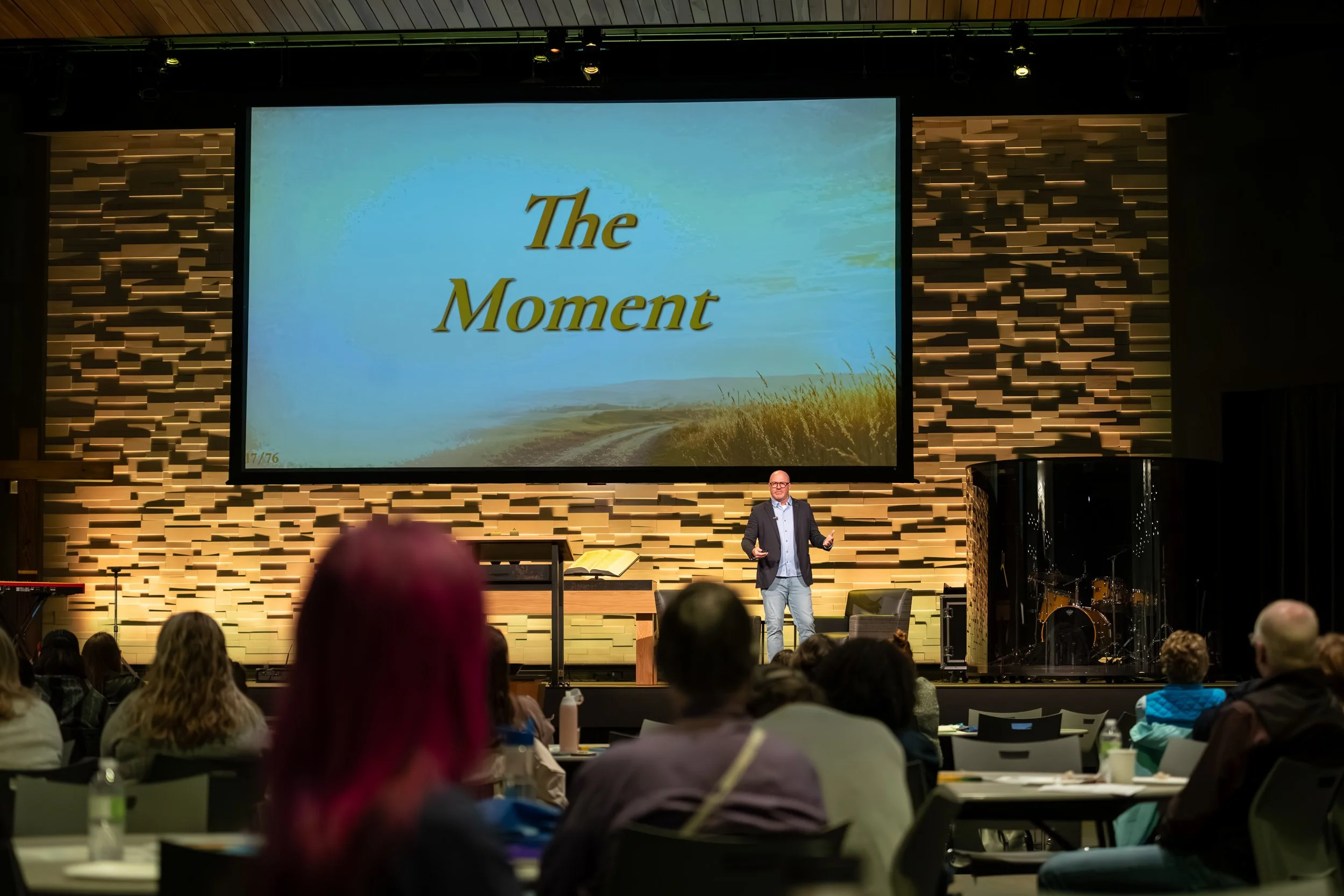 Kaleb Stoppel delivering a keynote presentation to a live audience.