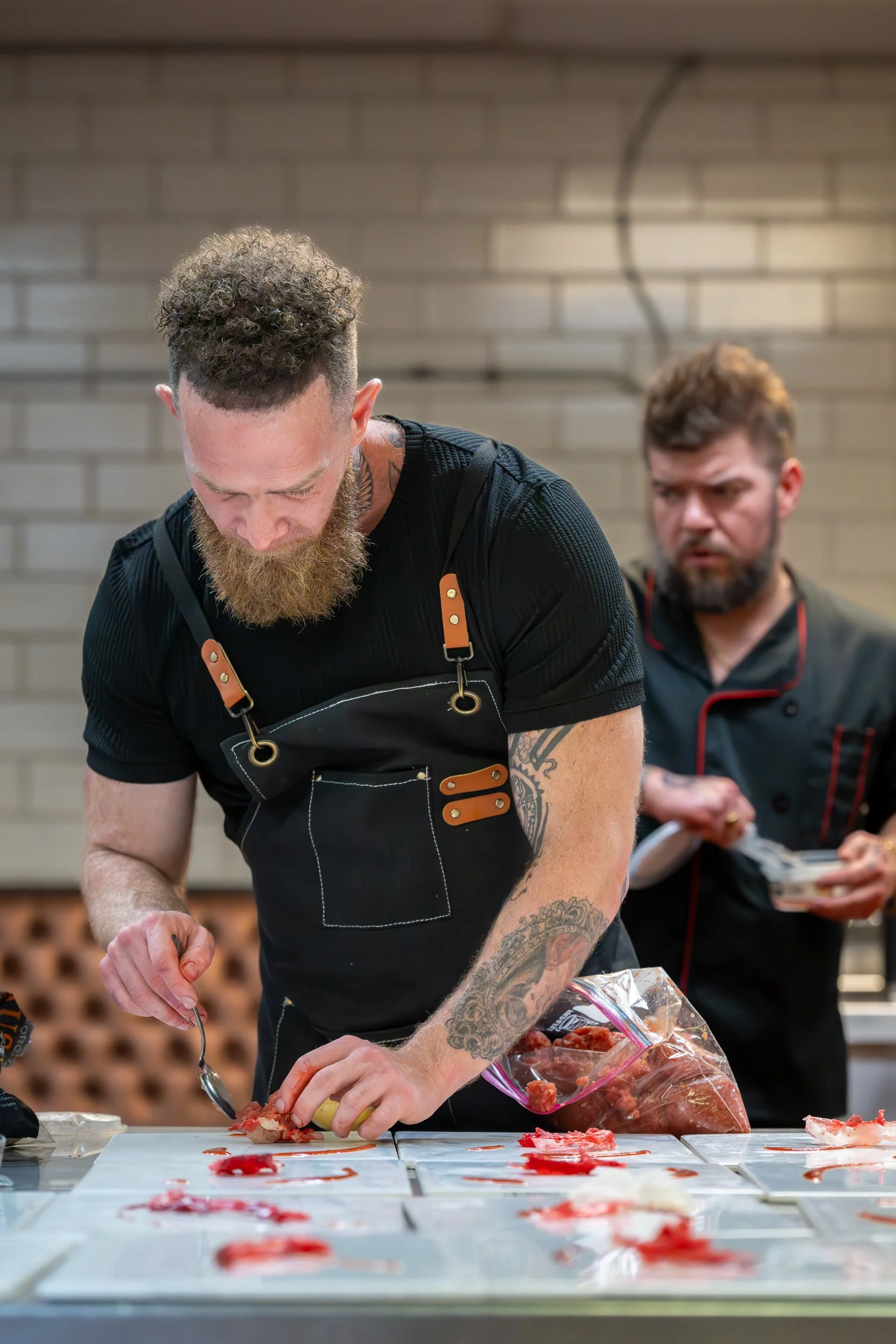 Chef Forrest Wright plating dishes during dinner service.