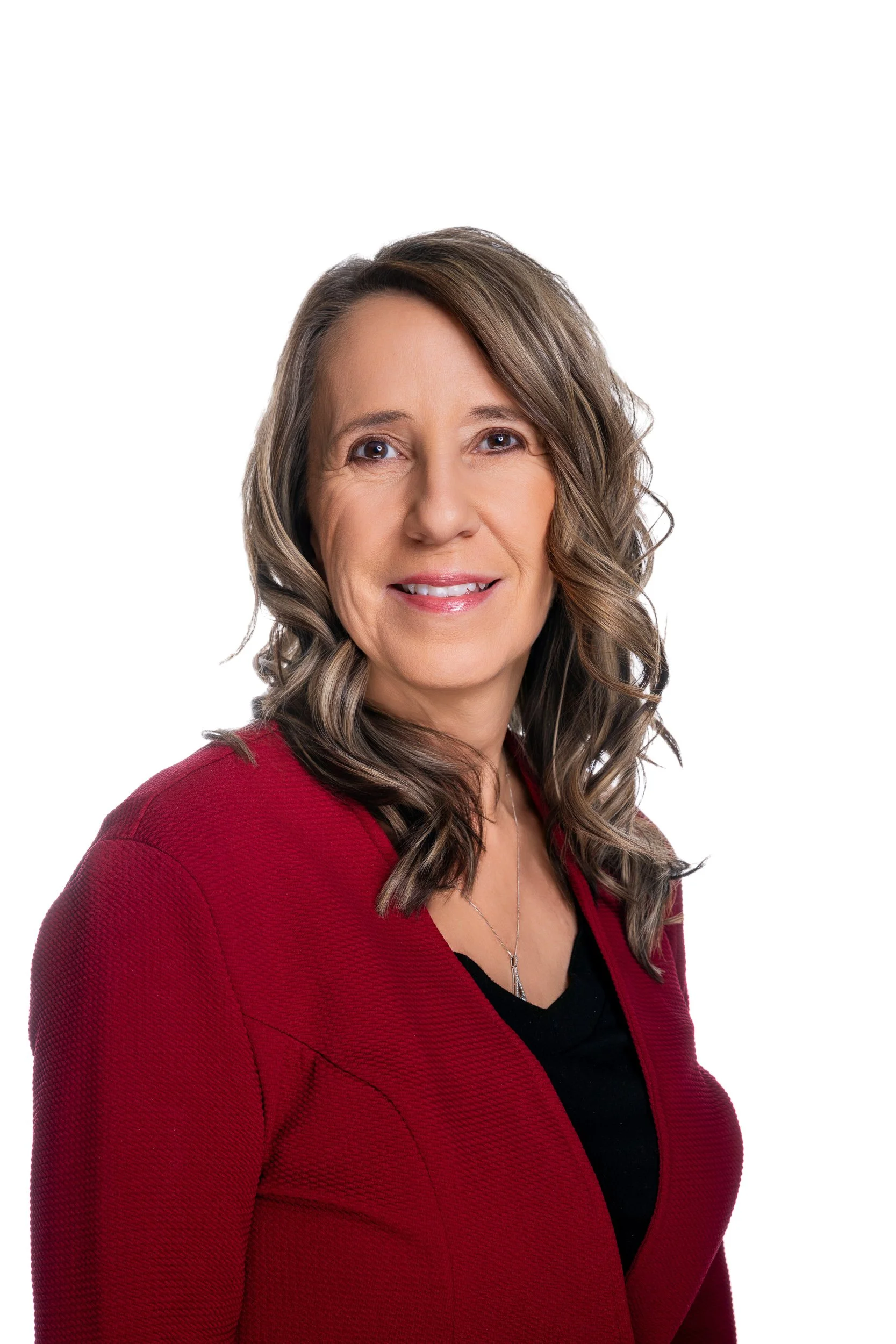 Woman in red blazer smiling against a white background