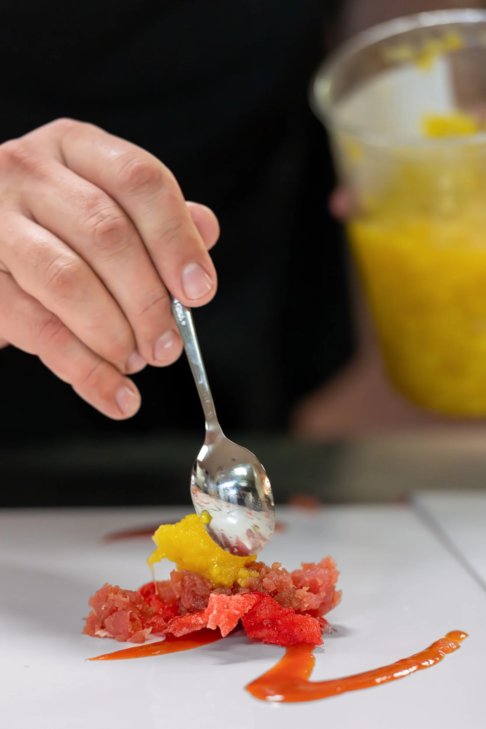 Chef carefully plating a course during dinner service.