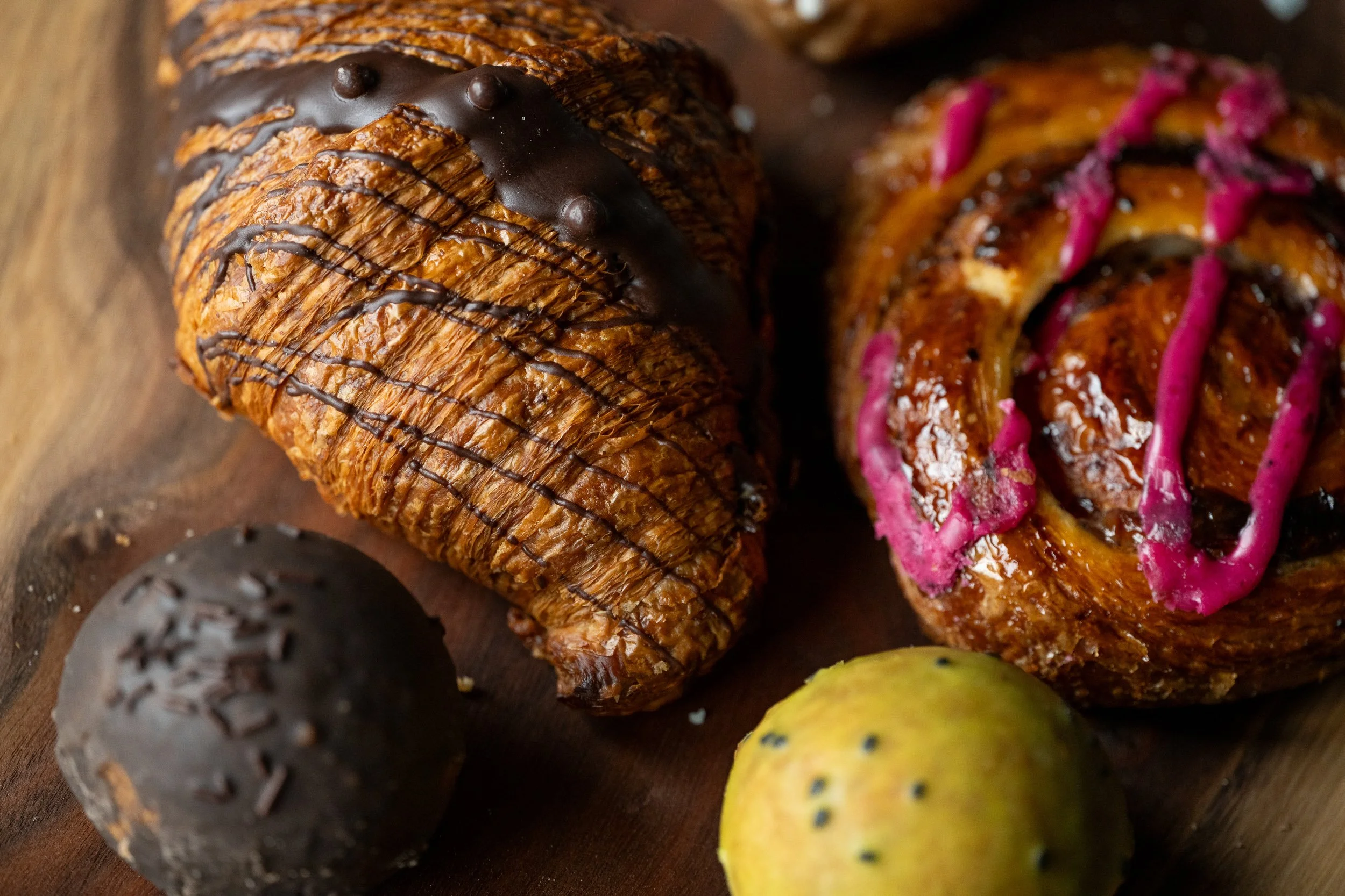 Artisan croissant and cinnamon roll with chocolate truffle, Kansas City bakery food photography
