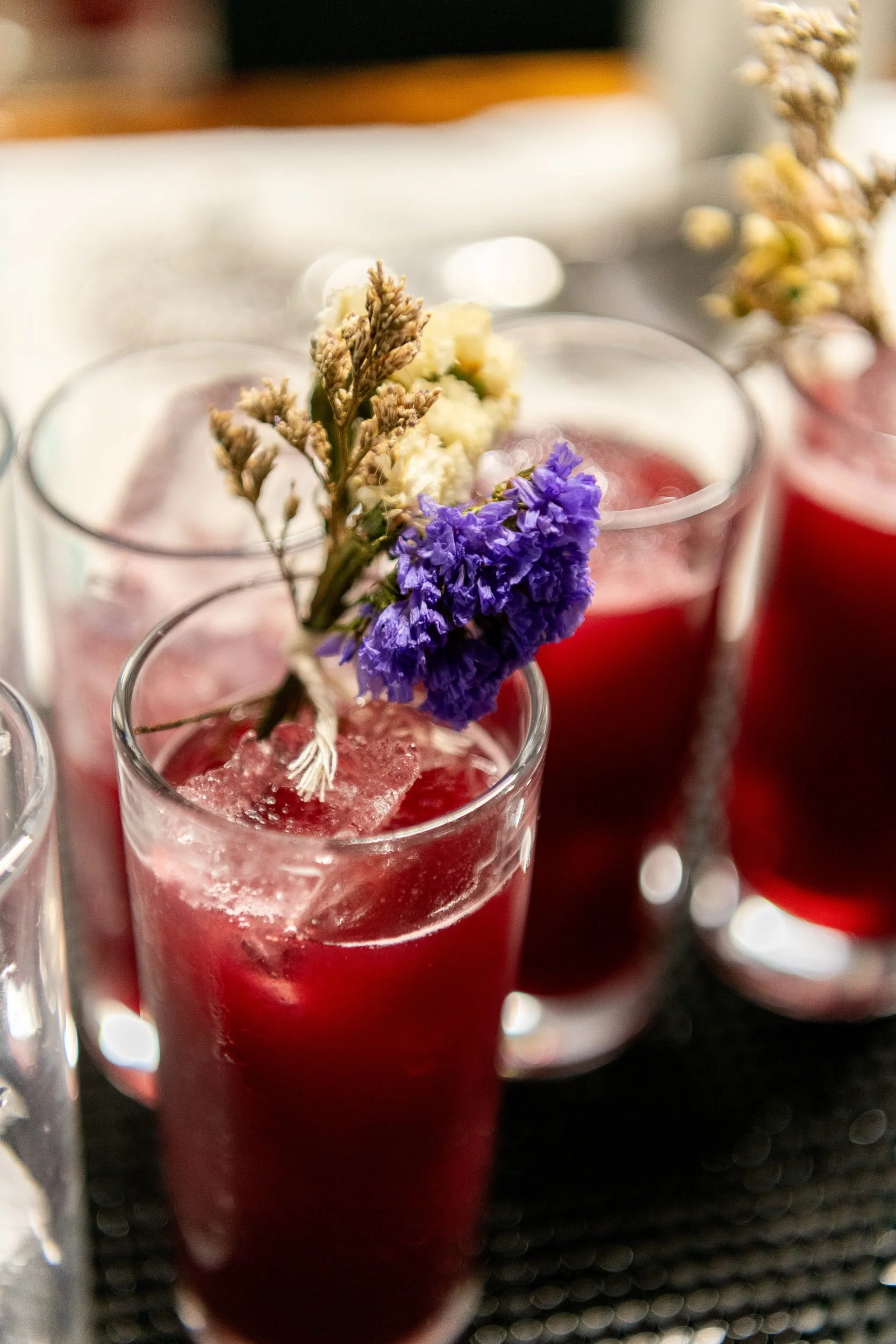 Beet cocktails with dried flower garnishes, craft cocktail photography fine dining event
