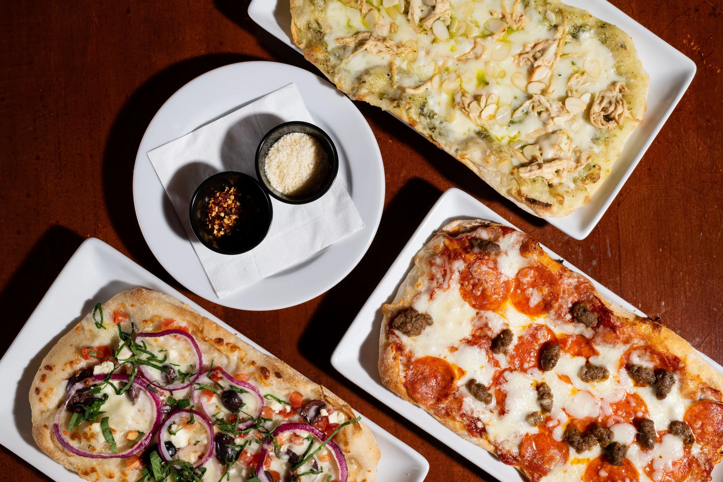 Pizza and pasta spread overhead, brewery restaurant menu photography Kansas City
