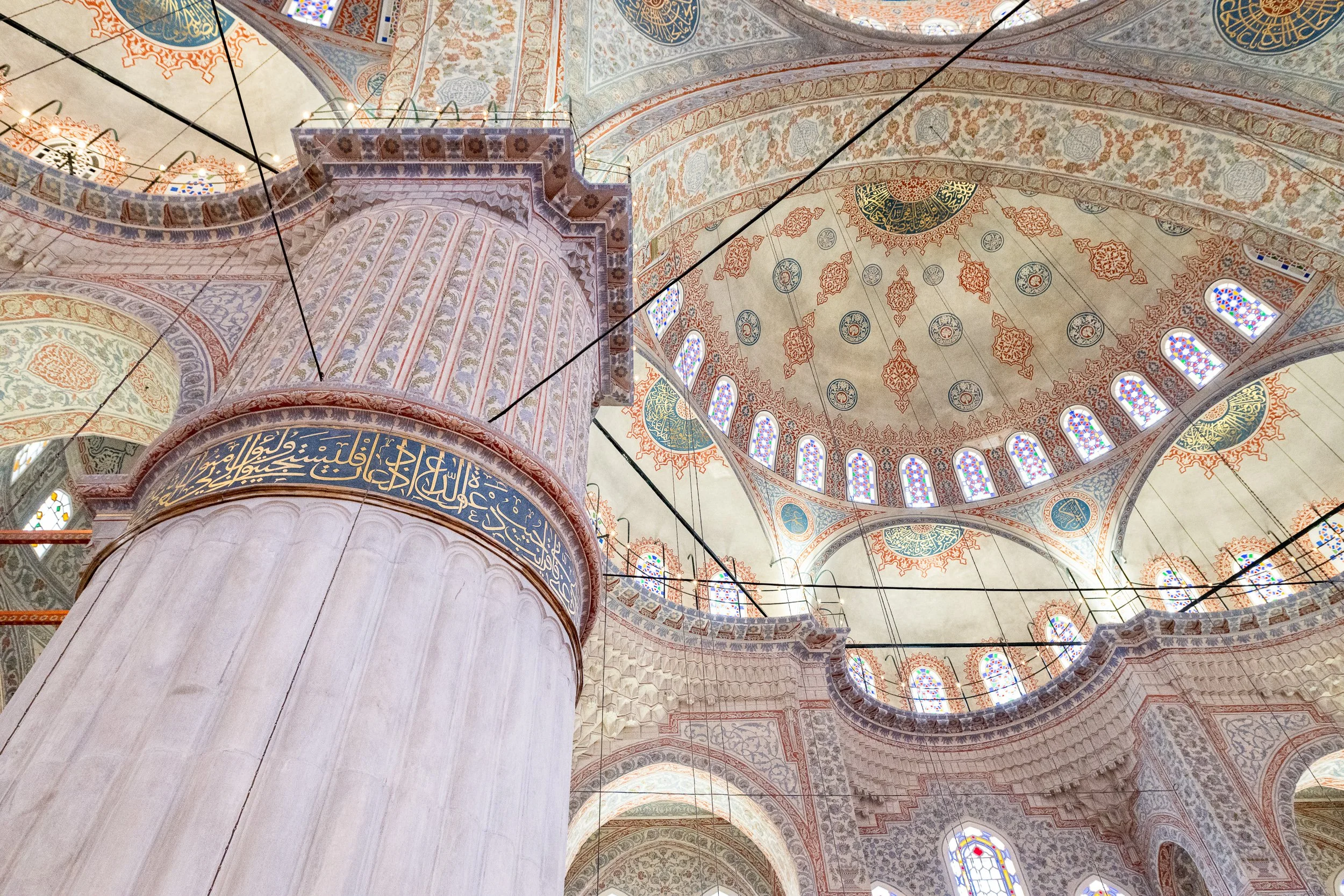 A towering marble column leads the eye upward through layers of domes, arches, and centuries of craftsmanship.