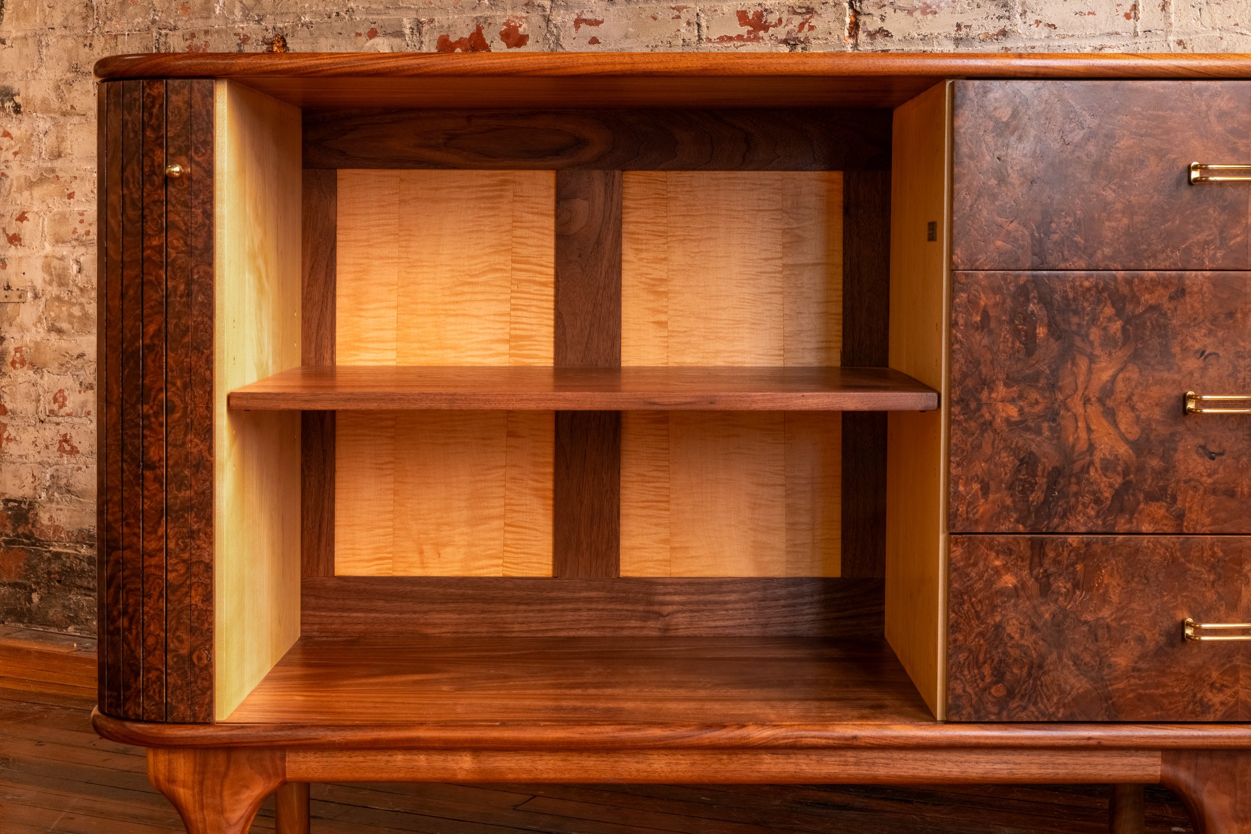 Interior shelving and tambour door construction inside the custom walnut credenza.
