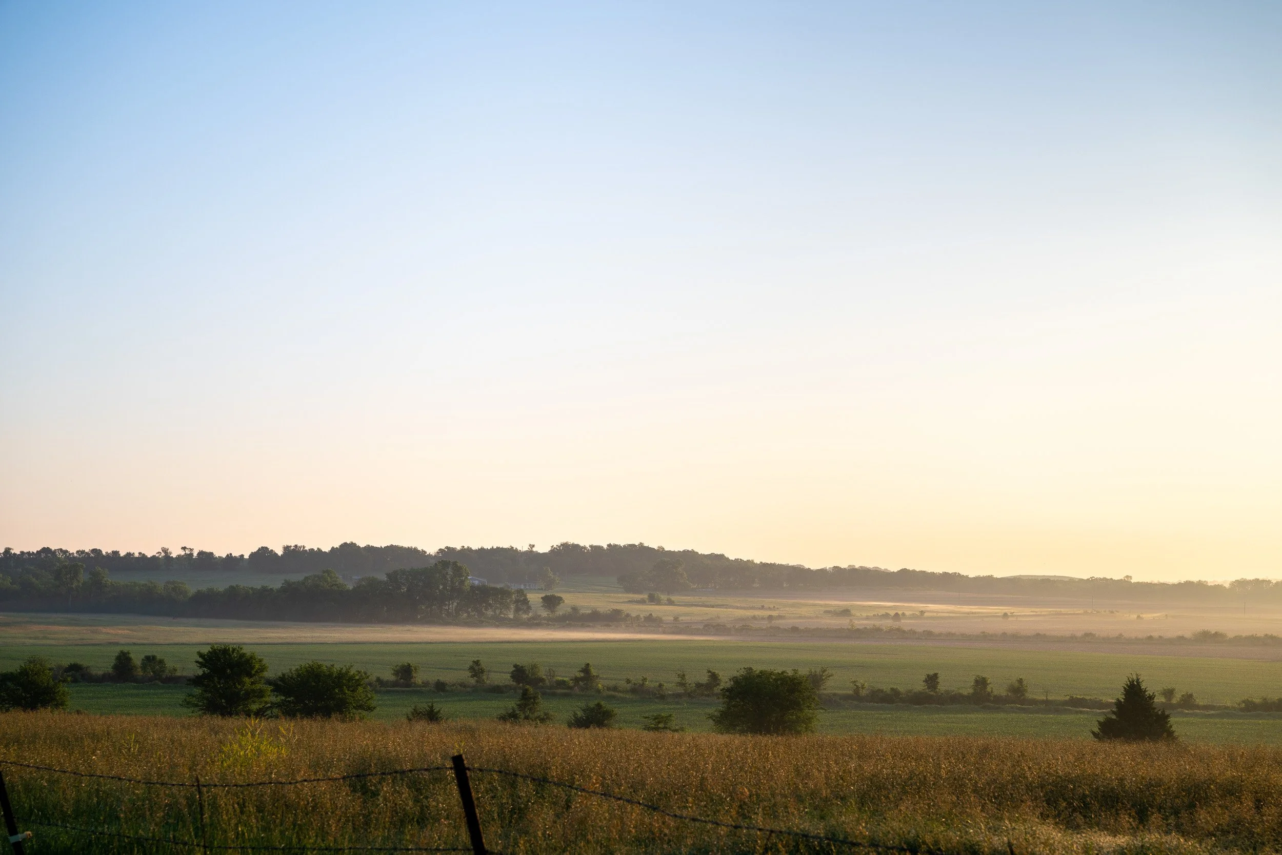Rolling farm fields in northeast Kansas at sunrise.