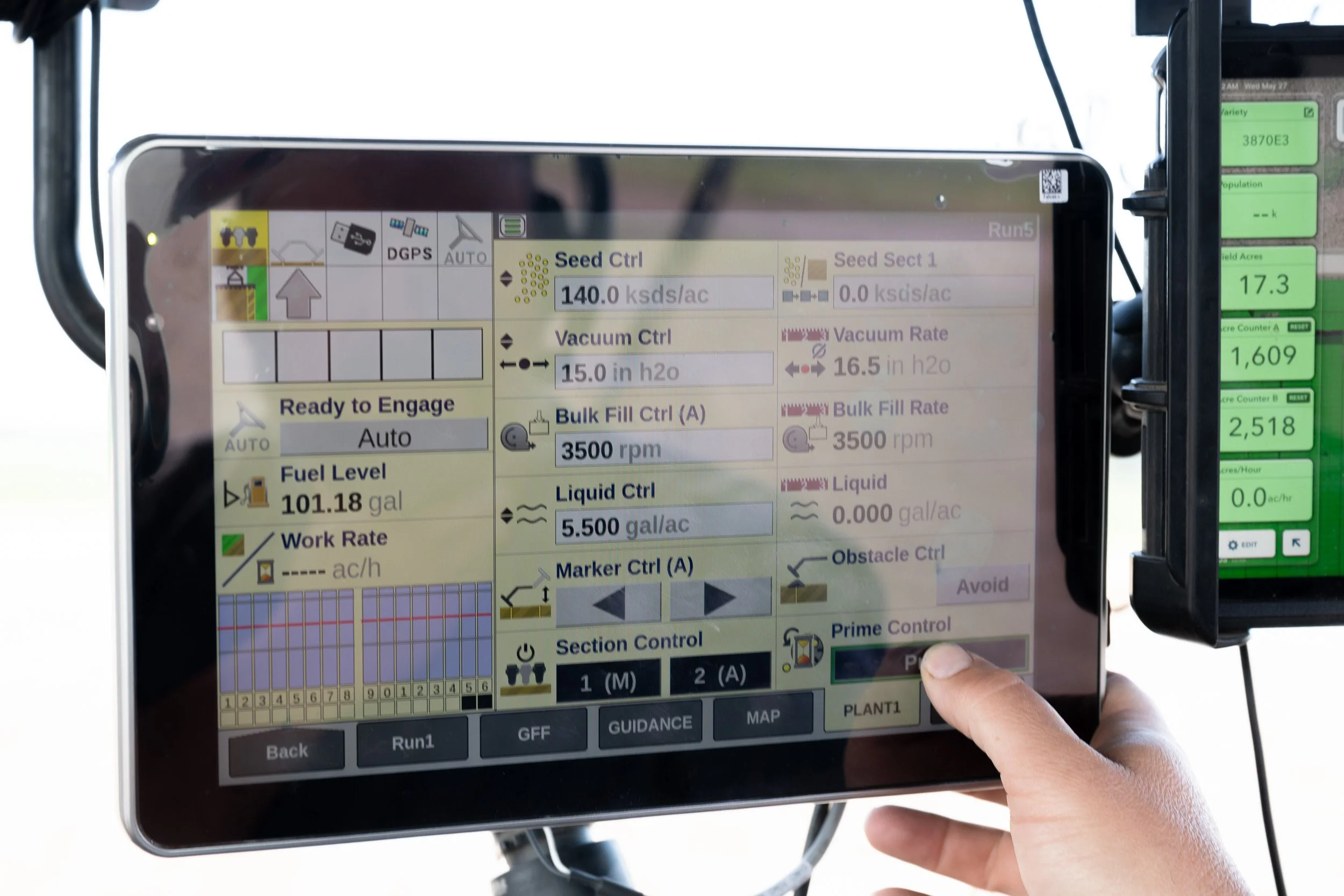 Tractor guidance display showing precision farming controls inside a cab.