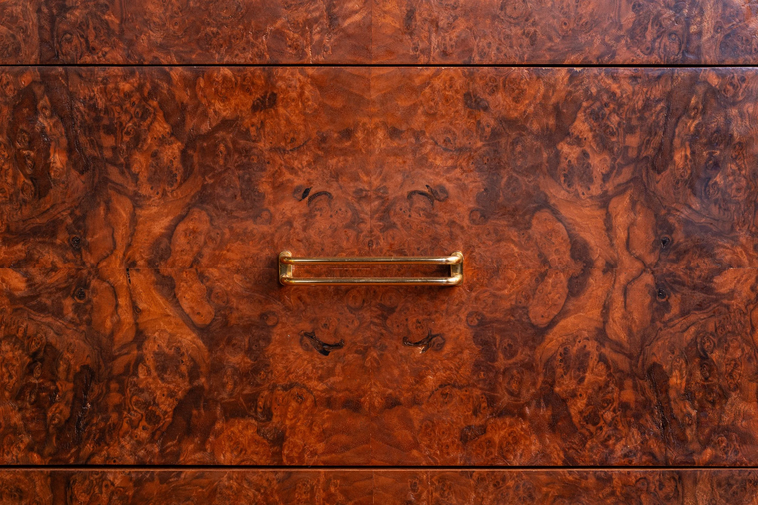 Bookmatched walnut burl veneer and brass drawer pull on the custom credenza.