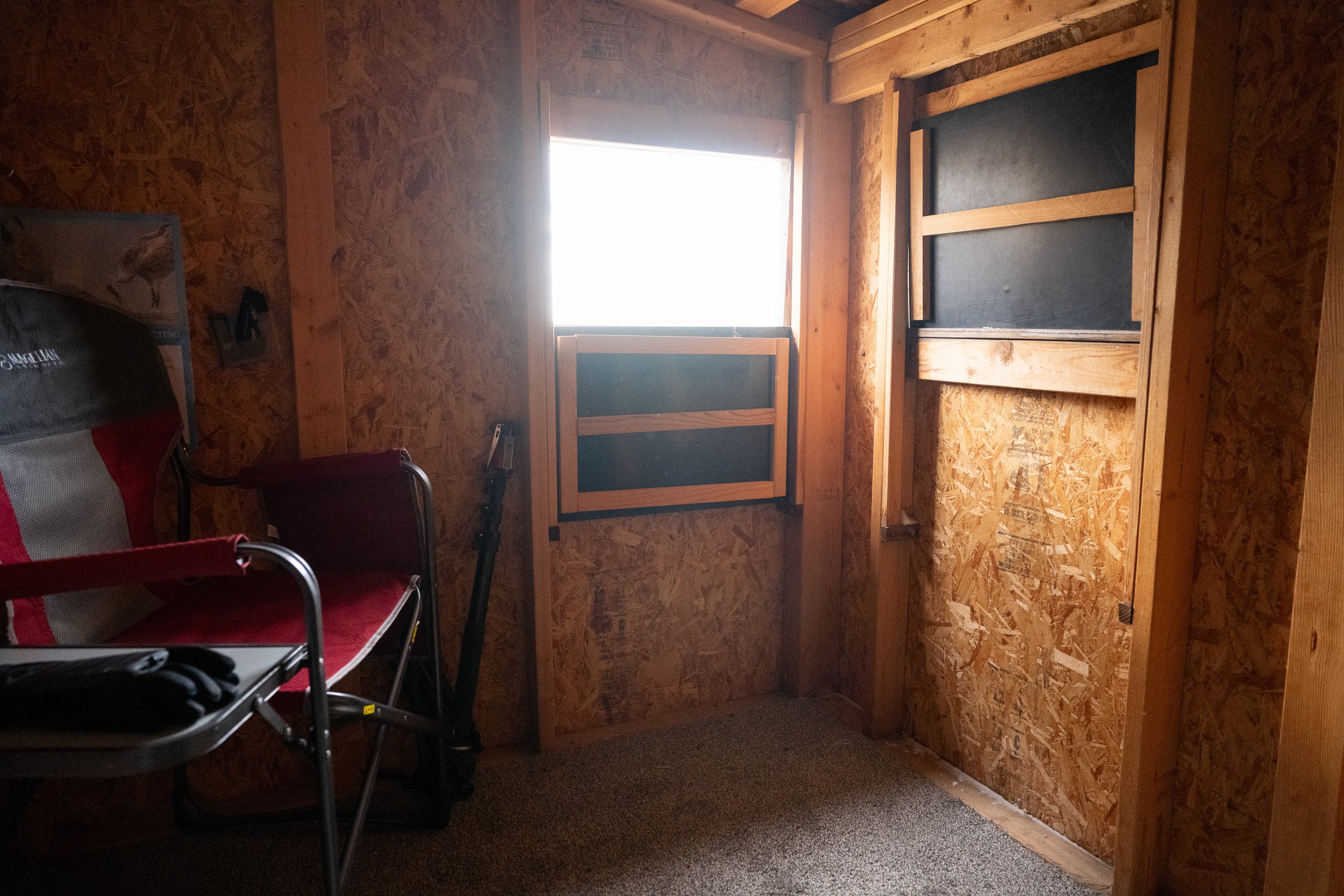 Interior of a photography blind with viewing windows facing the Platte River.
