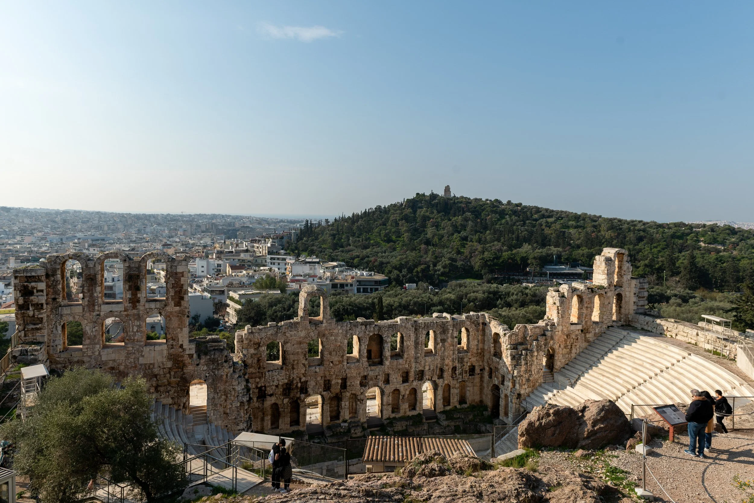 Odeon of Herodes Atticus theater ruins on the Acropolis slope, Athens, Greece, with the modern city below.