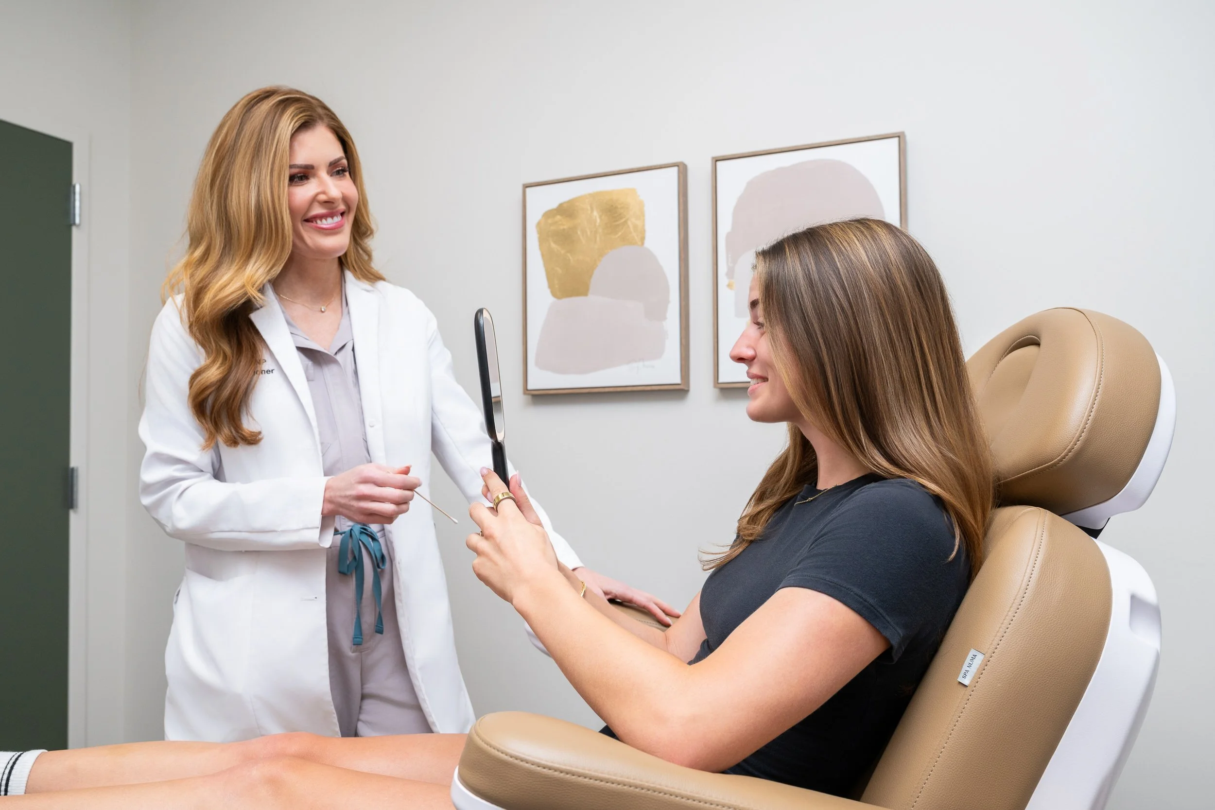 Medical aesthetics provider consulting with a patient in a treatment room at Bella Derma.
