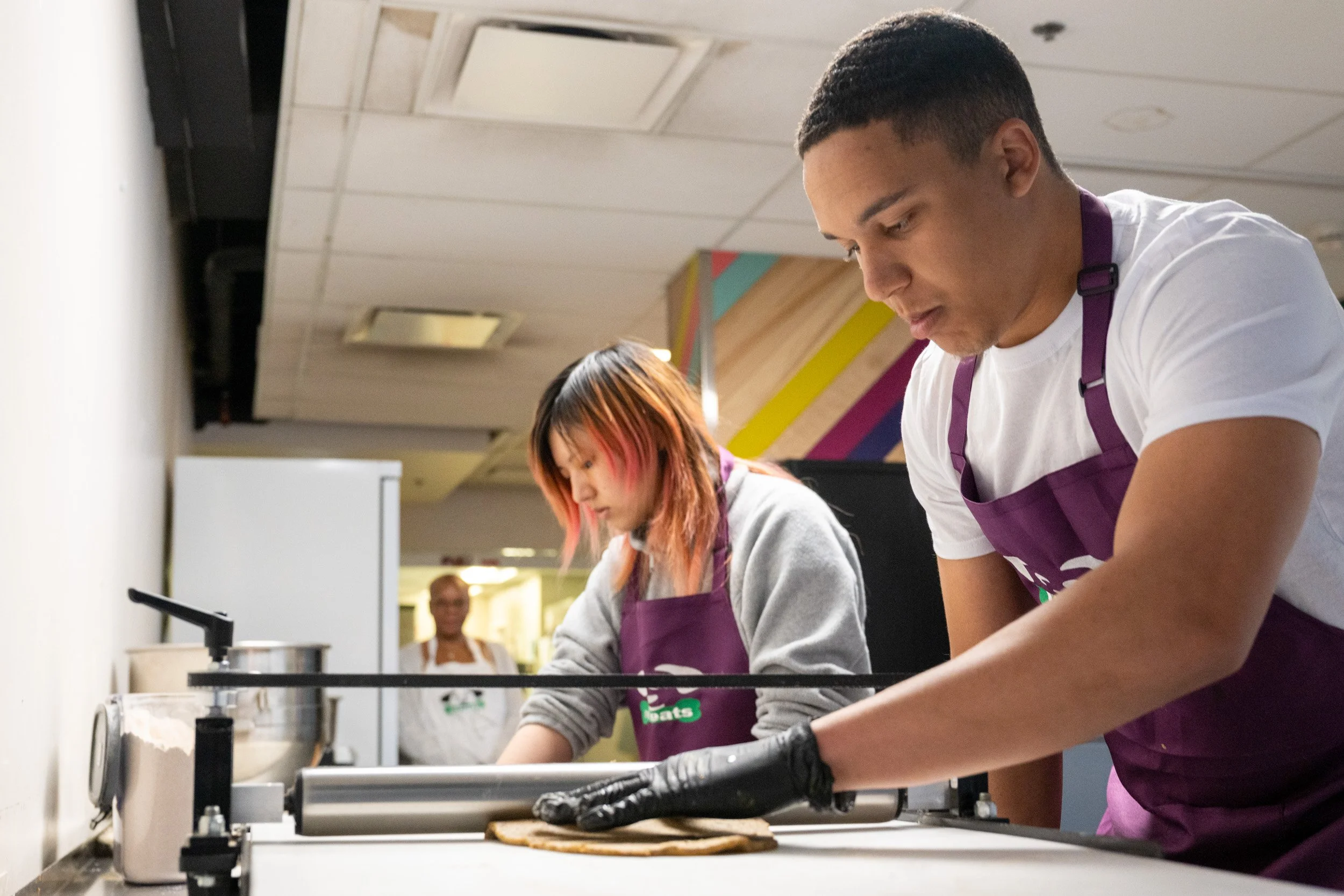 Participant preparing dog treats during a reStart youth employment program.