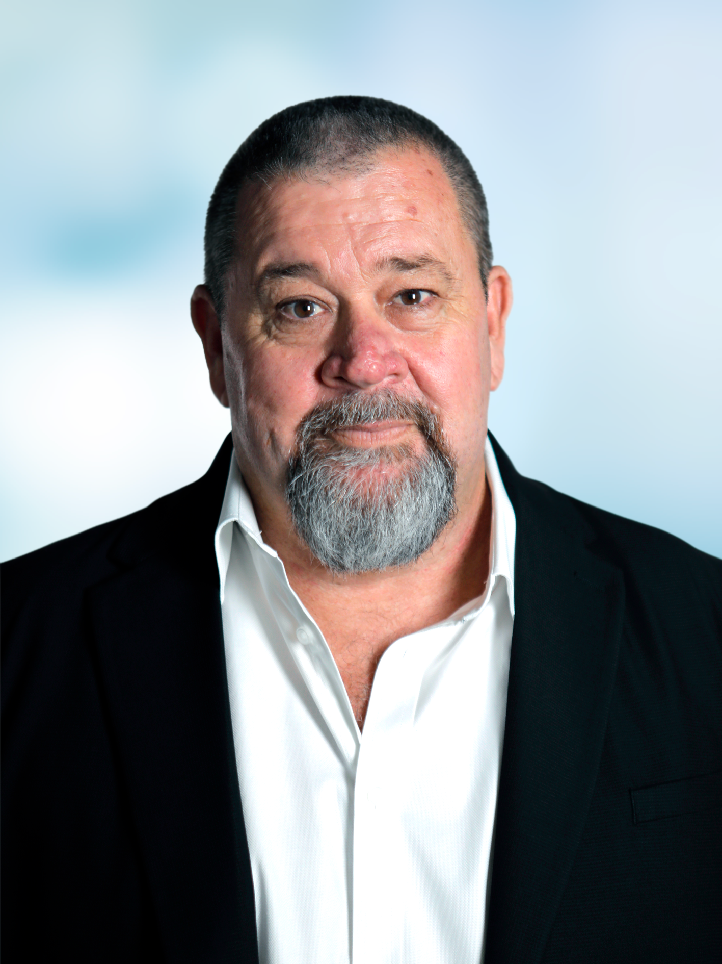 A man with short hair and a grey beard