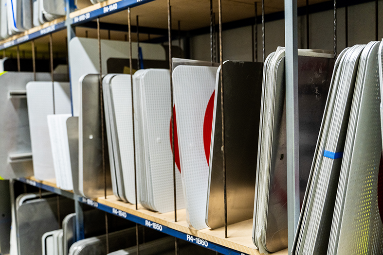 Metal trays displayed on store shelves.