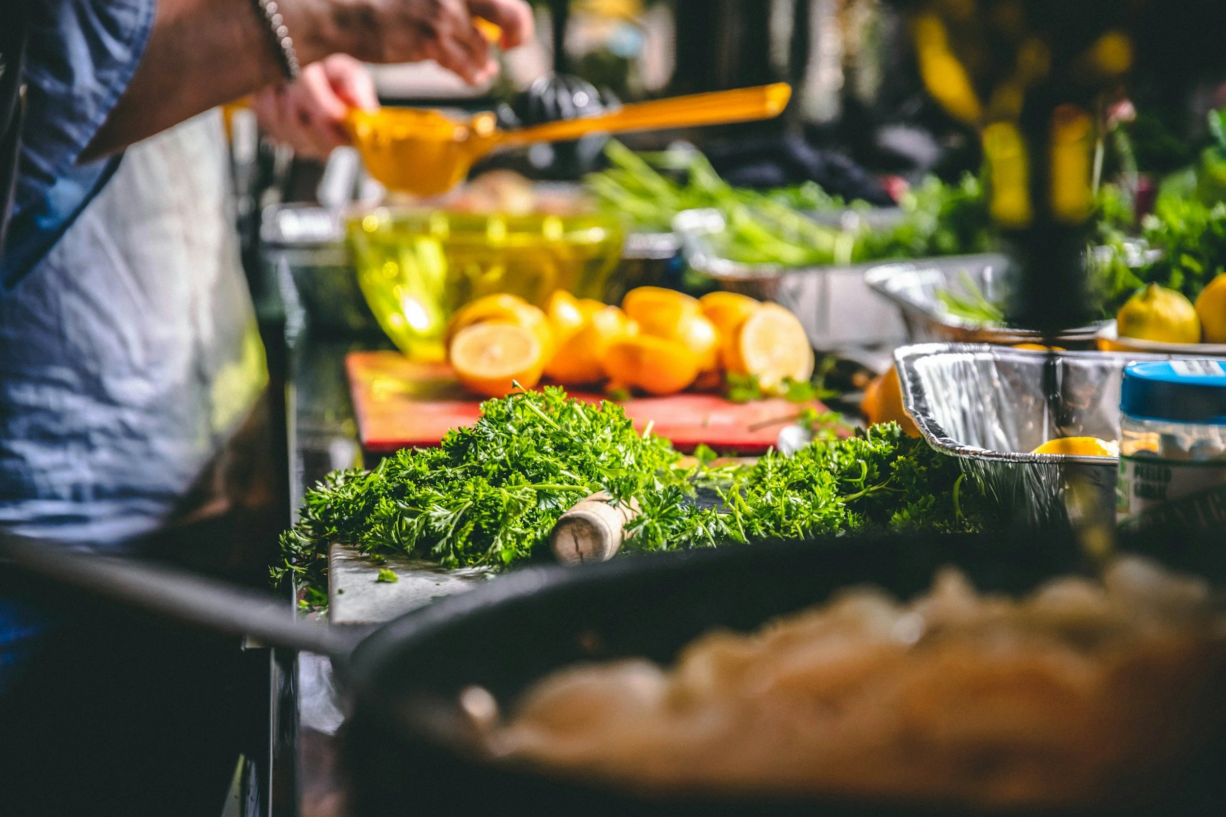 Photo of chef preparing meal with parsley and lemons